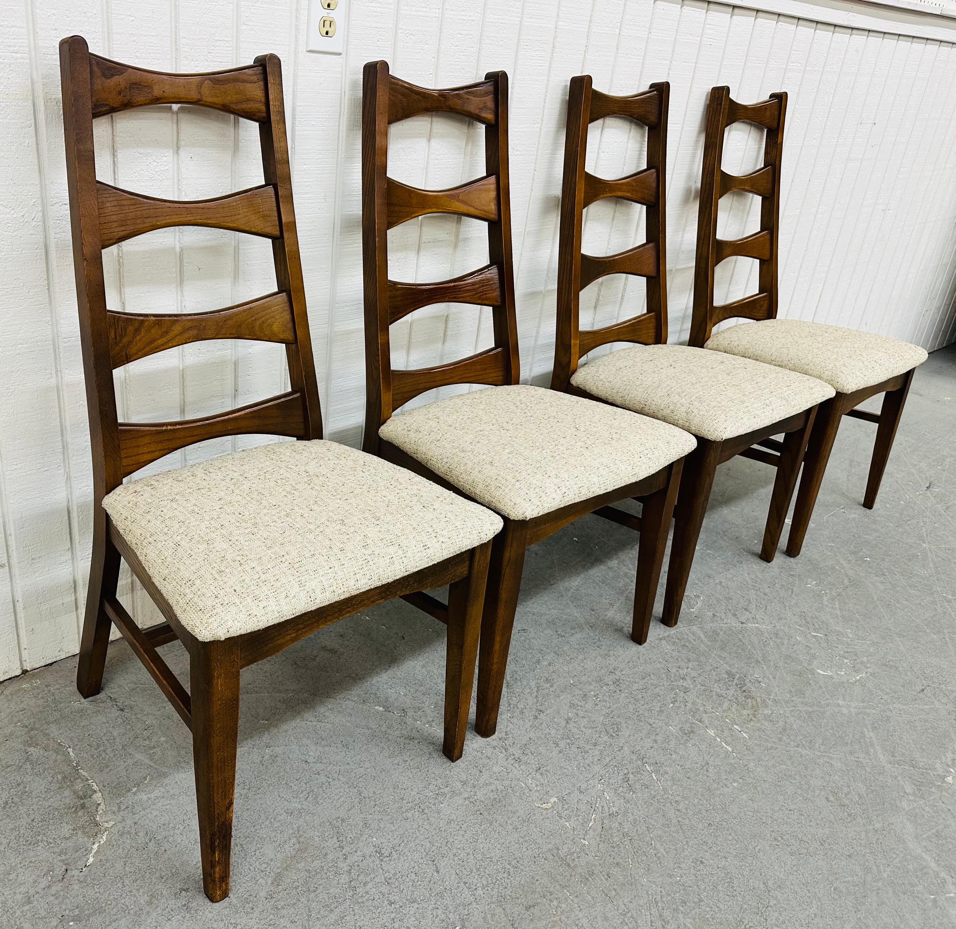 This listing is for a set of four Mid-Century Modern Lane Style Walnut Dining Chairs. Featuring a ladder back design, modern legs, newly upholstered seats, and a beautiful walnut finish. This is an exceptional combination of quality and design!
