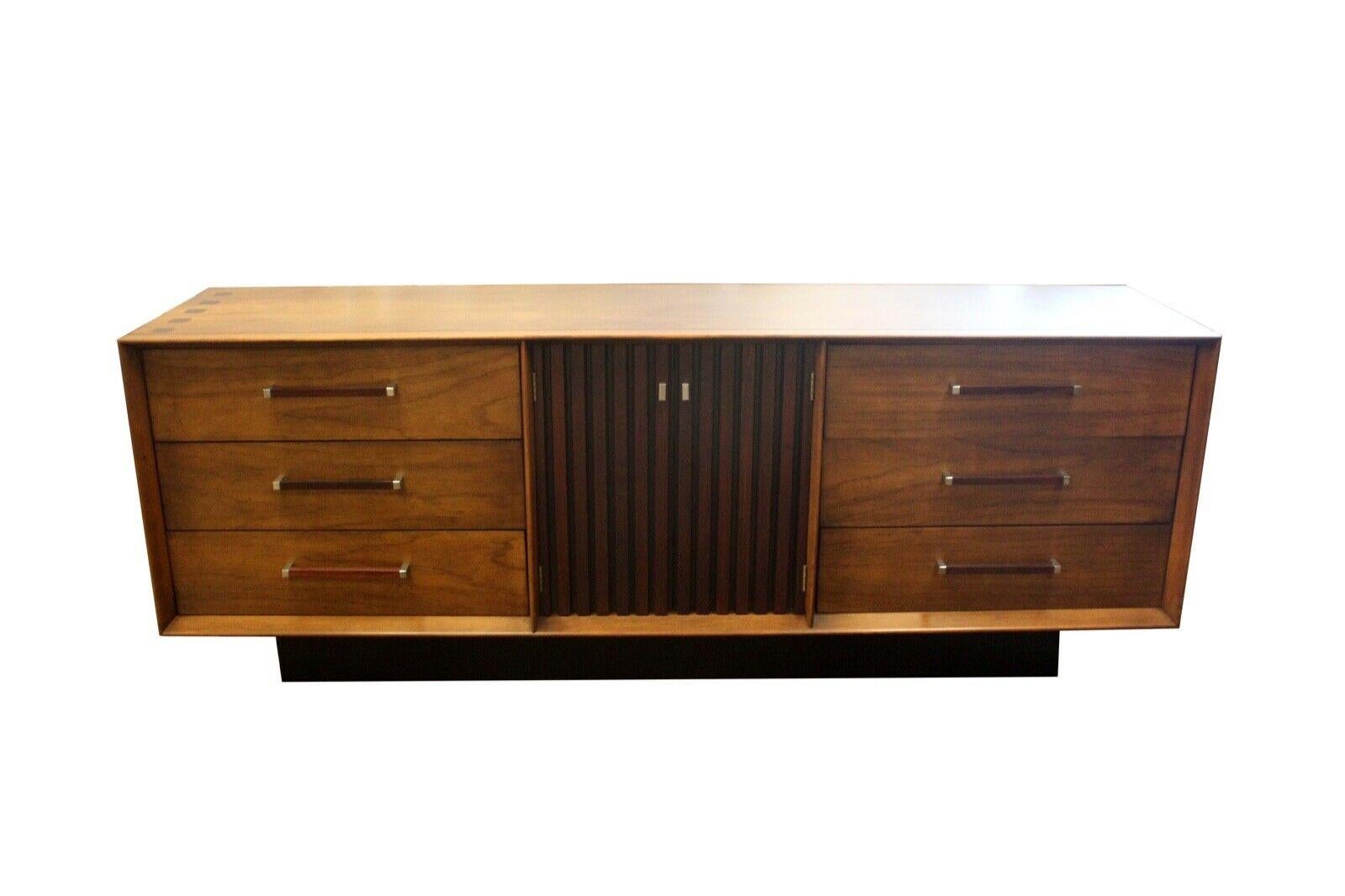 From Le Shoppe Too in Michigan comes this wonderful vintage modern six drawer lowboy dresser with storage. Known as the Lane 'Tower' Suite, this unique two-tone design with walnut casing and rosewood accents offers both beauty as well as quality.