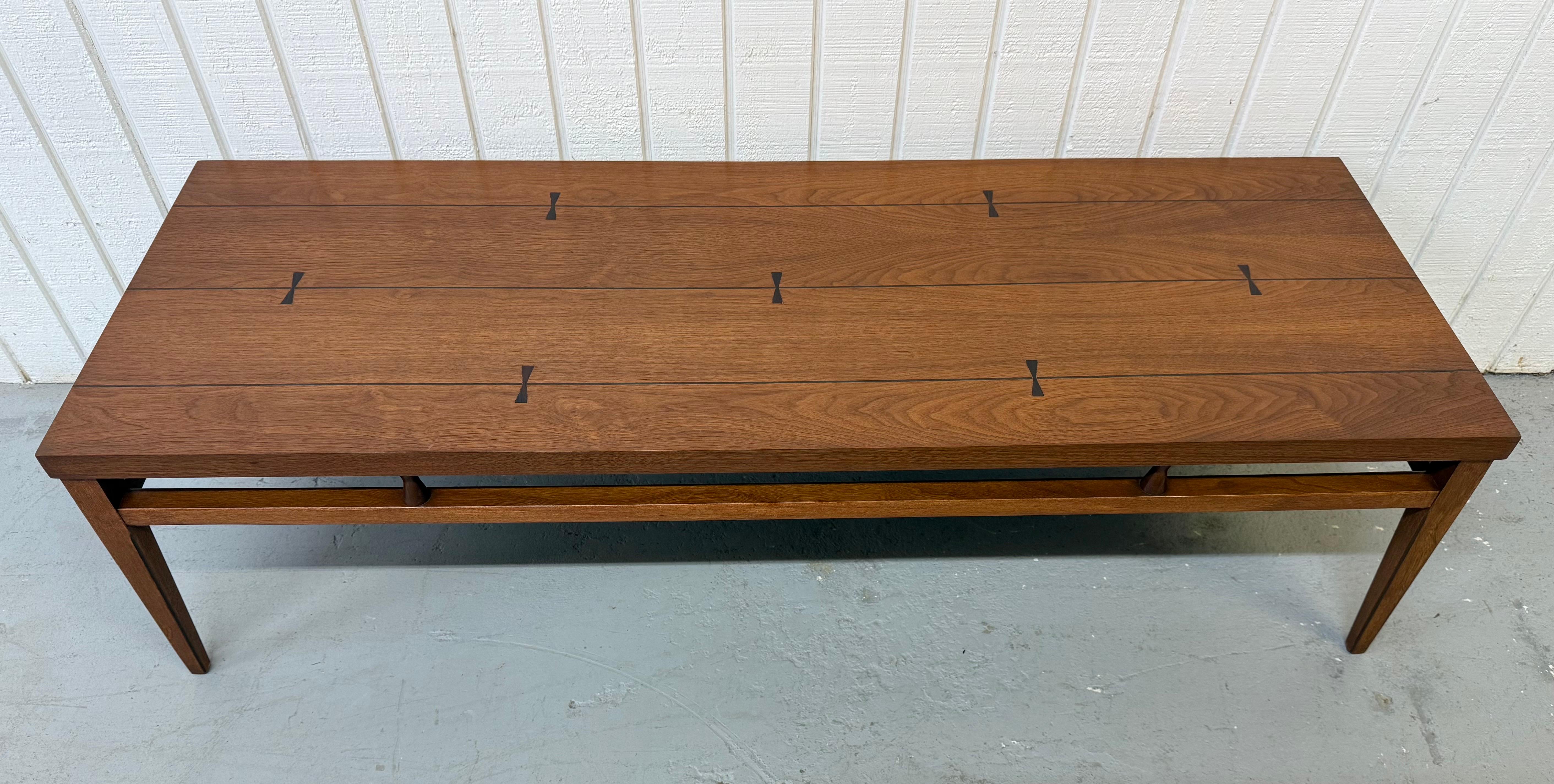 This listing is for a Mid-Century Modern Lane Tuxedo Walnut Coffee Table. Featuring a straight line design, rectangular top with rosewood inlay, modern legs, and a beautiful walnut finish. This is an exceptional combination of quality and design by