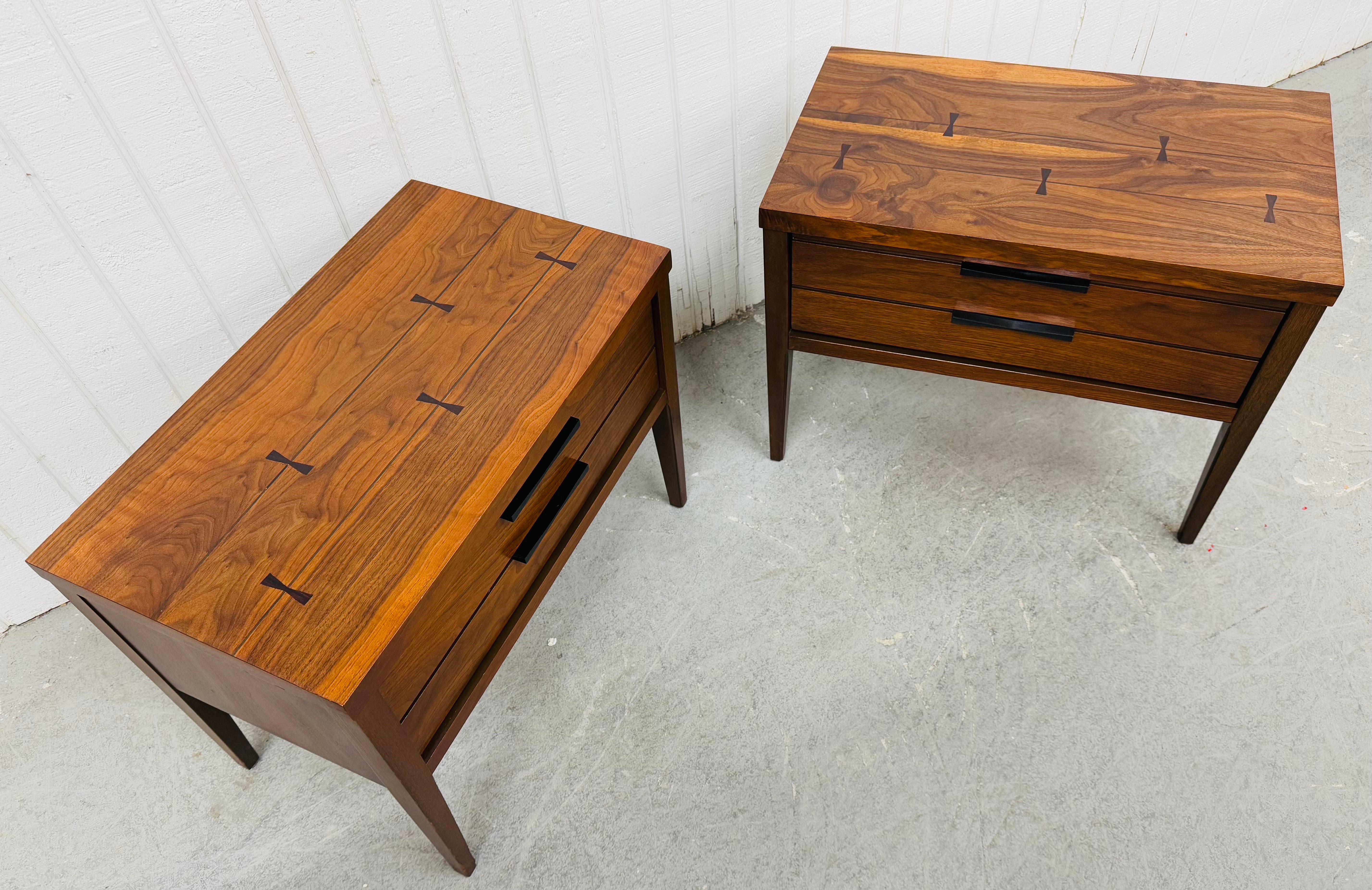 This listing is for a pair of Mid-Century Modern Lane Tuxedo Walnut Nightstands. Featuring a straight line design, single drawer with original black Tuxedo hardware, long modern legs, rosewood inlay on the top, and a beautiful walnut finish. This is