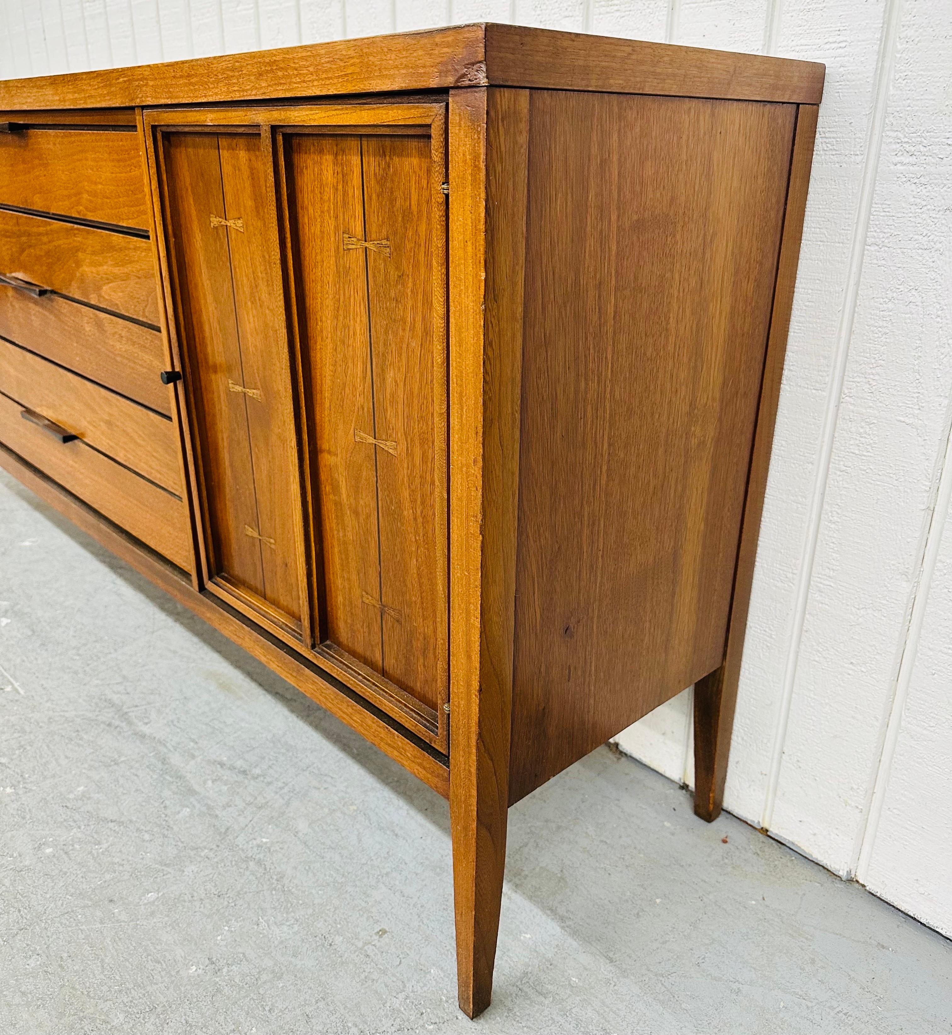 This listing is for a Mid-Century Modern Lane Tuxedo Walnut Sideboard. Featuring a straight line design, doors on each end that open up to fixed shelving space, three center drawers, original black hardware, tuxedo inlays, and a beautiful walnut