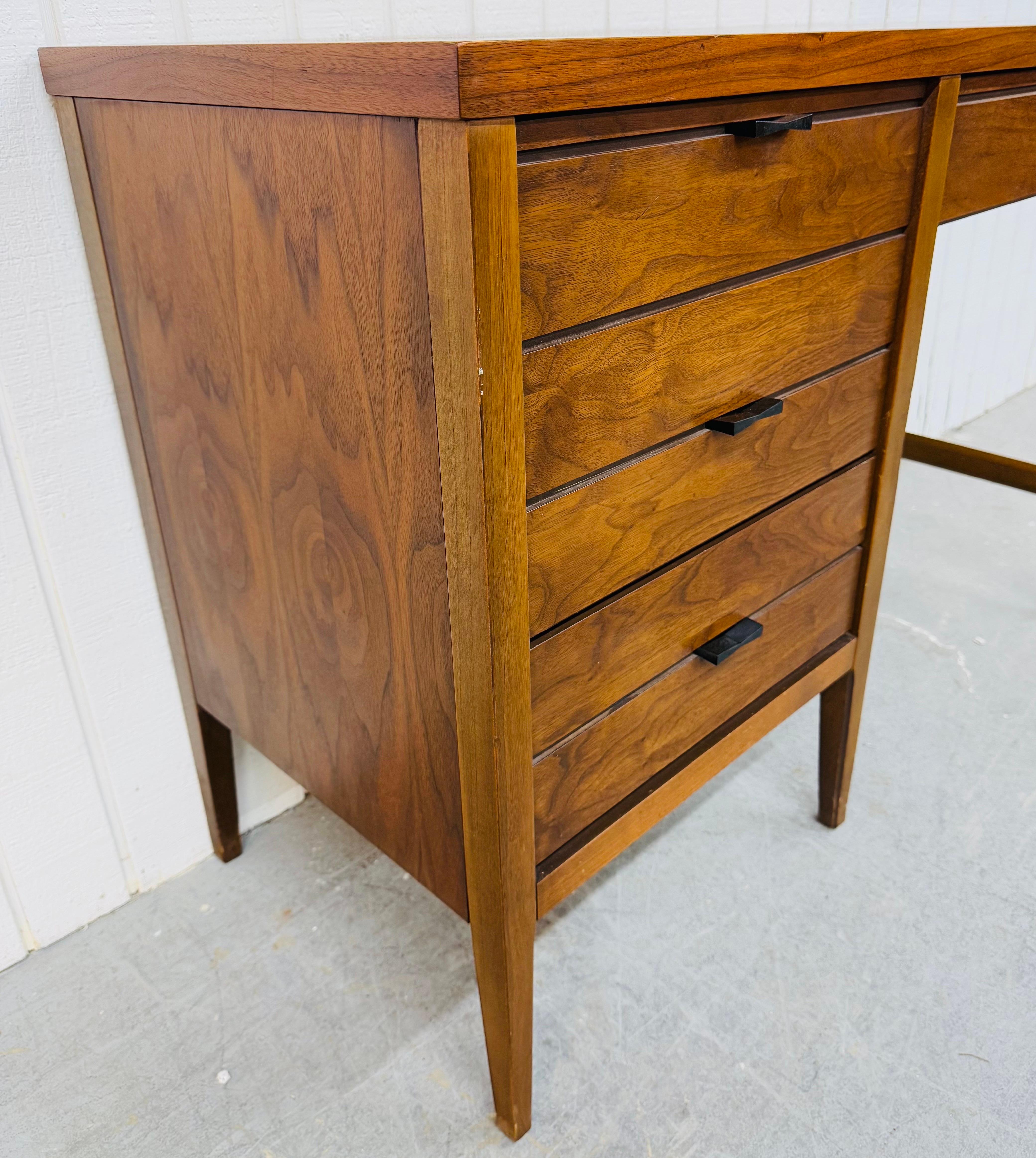 This listing is for a Mid-Century Modern Lane Tuxedo Walnut Writing Desk. Featuring a straight line design, rectangular top with rosewood inlay, three drawers for storage, original black metal hardware, modern legs, and a beautiful walnut finish.