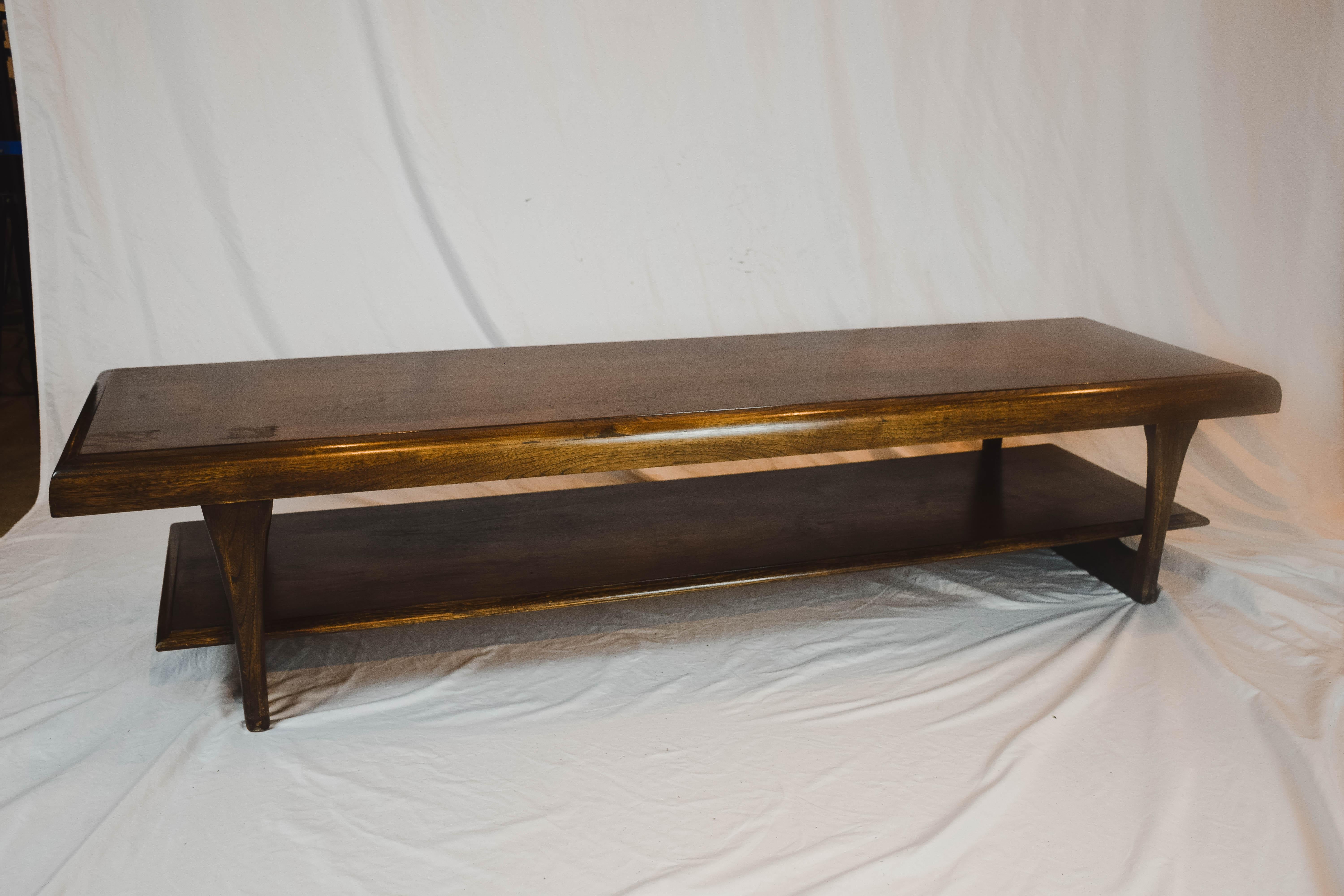 A gorgeous vintage Lane Furniture long coffee table that features classic midcentury design, coupling a two-tier construction, beautiful solid walnut grain and hallmarked on the underside Lane Altavista, Virginia. This table shows an indented