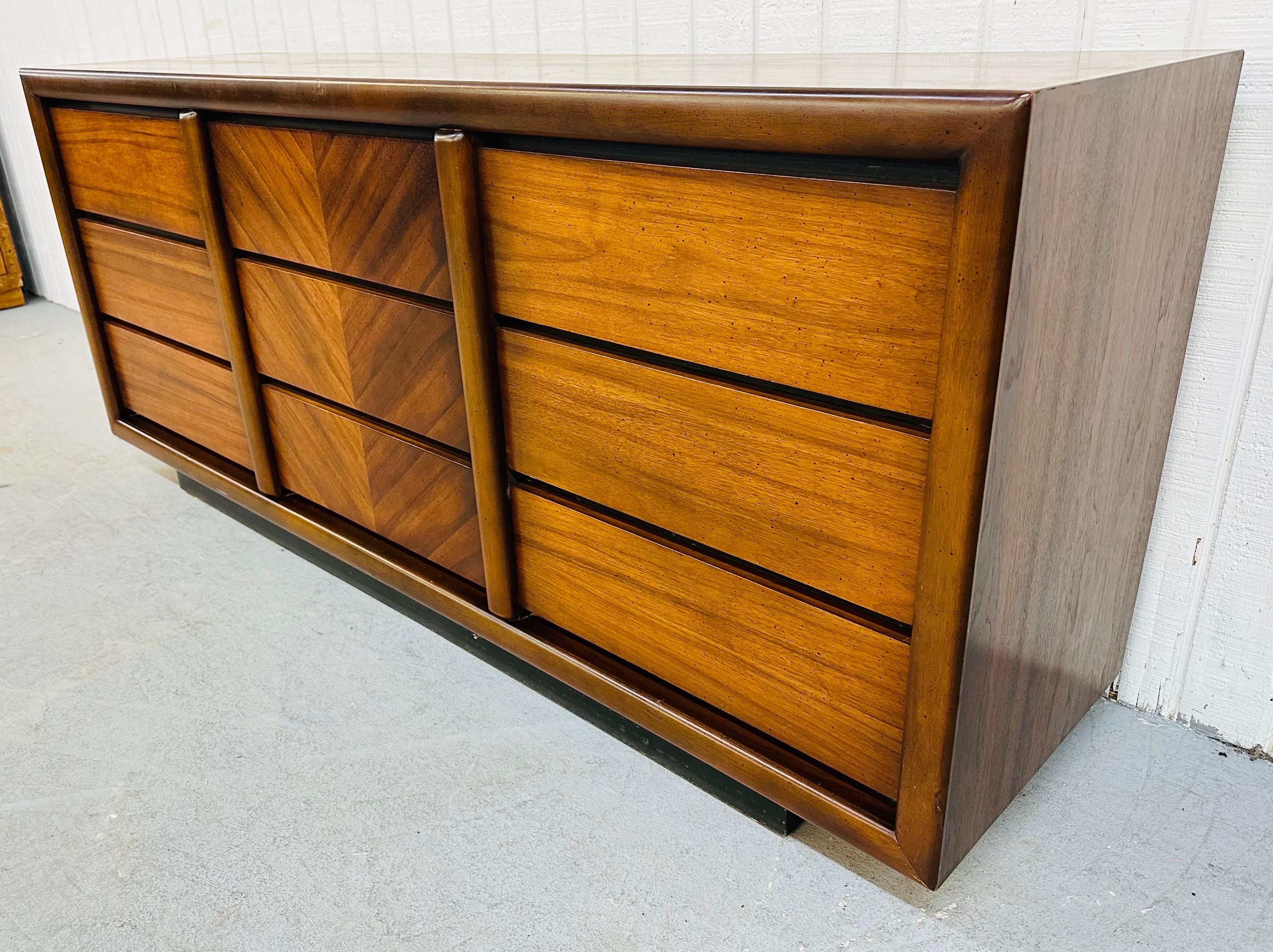 This listing is for a Mid-Century Modern Lane Walnut 9-Drawer Dresser. Featuring nine evenly sized drawers for storage, black plinth base, and beautiful walnut finish. This is an exceptional combination of quality and design by Lane.