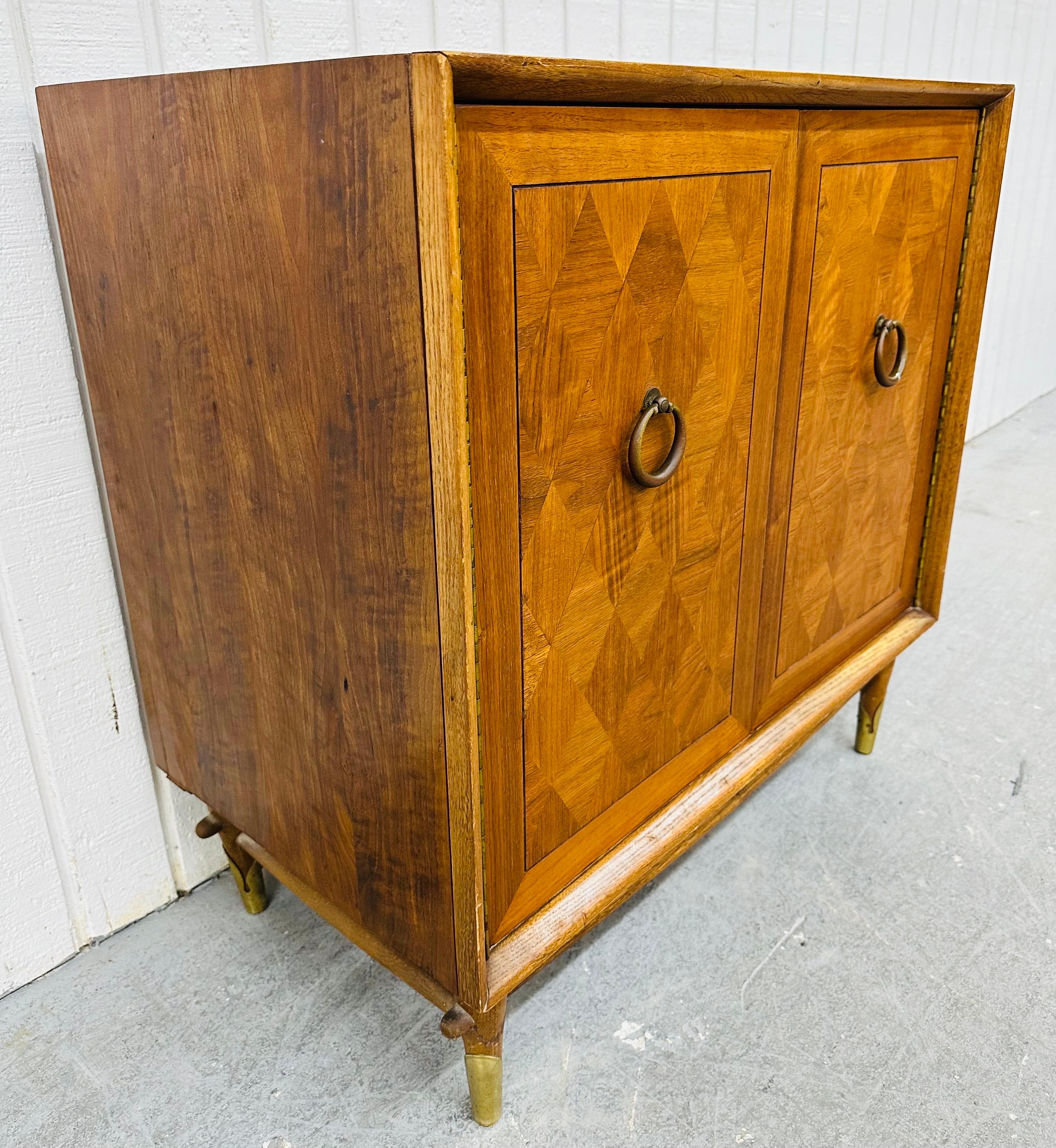 This listing is for a Mid-Century Modern Lane Walnut Cedar Cabinet. Featuring a straight line design, two doors with brass pulls that open up to cedar lined storage space, modern legs with brass caps, stretcher base, and a beautiful walnut finish.