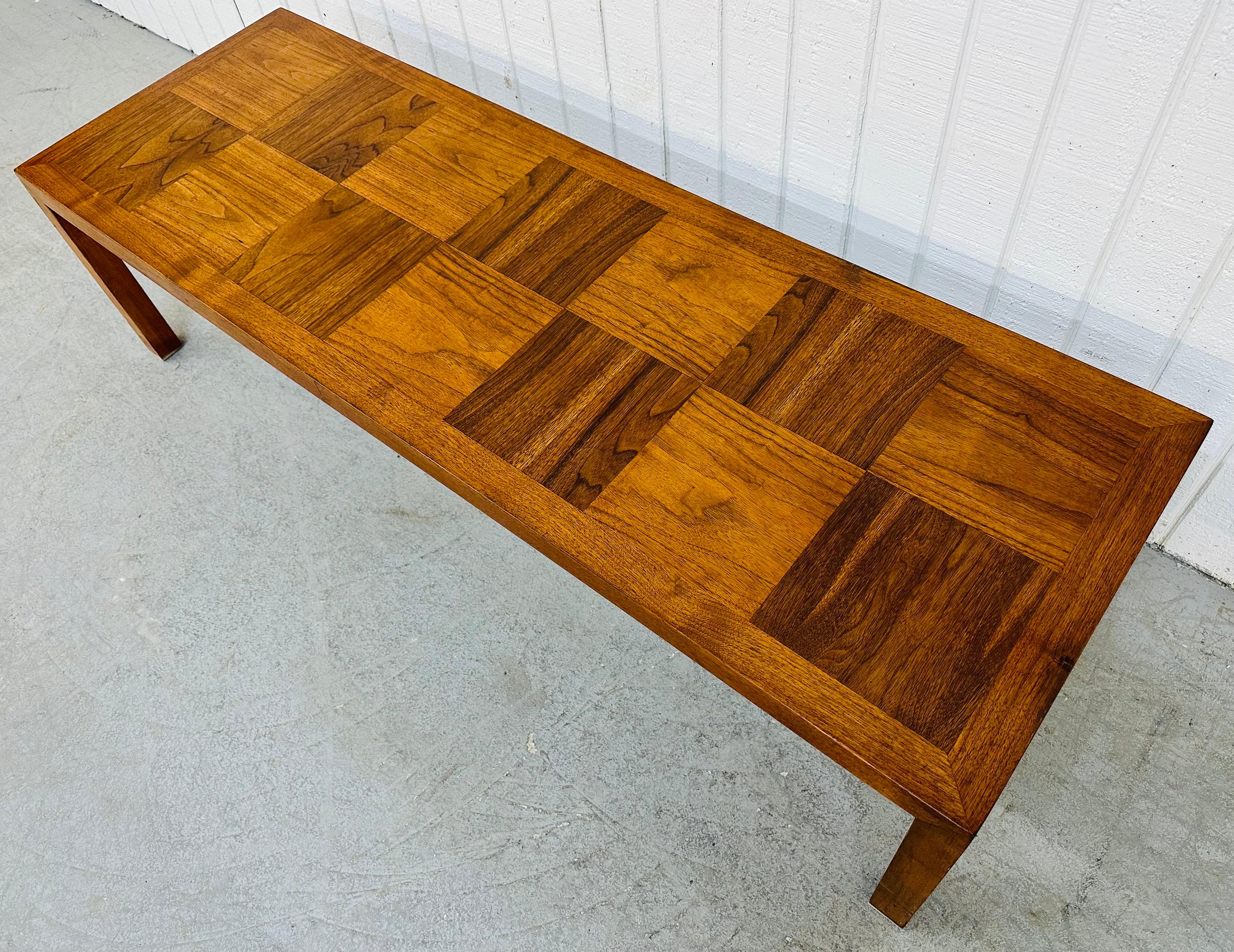 This listing is for a Mid-Century Modern Lane Walnut Coffee Table. Featuring a two-tone walnut checkerboard style rectangular top, straight line attached legs, and a beautiful walnut finish. This is an exceptional combination of quality and modern