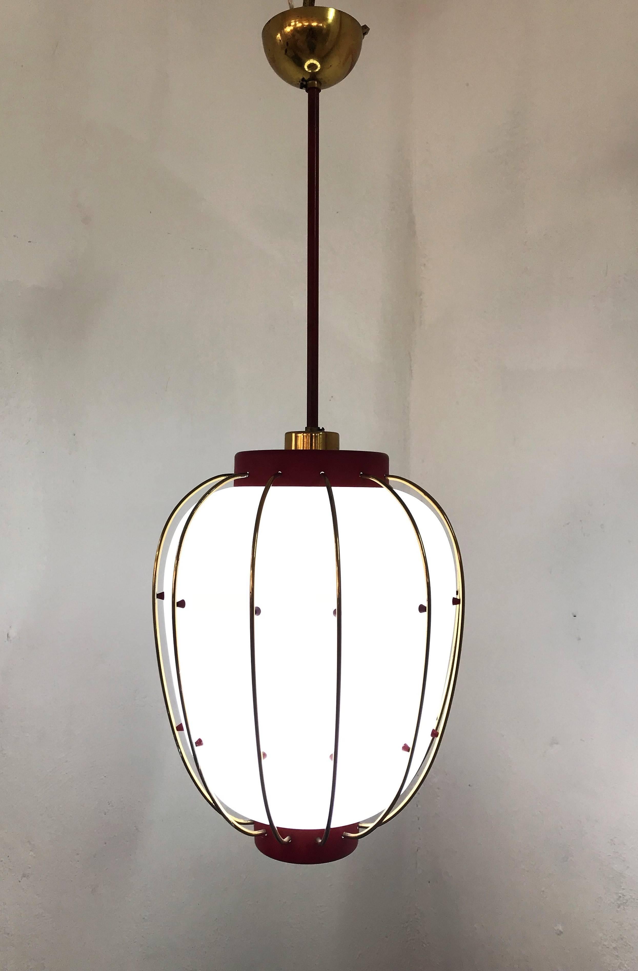 Beautiful pendant light in red lacquered metal, brass and opaline glass, attributed to Stilnovo and very much in the manner of Angelo Lelii's designs for Arredoluce.
This lantern holds one bulb.
Measurements:
Height 71cm (35cm H body of