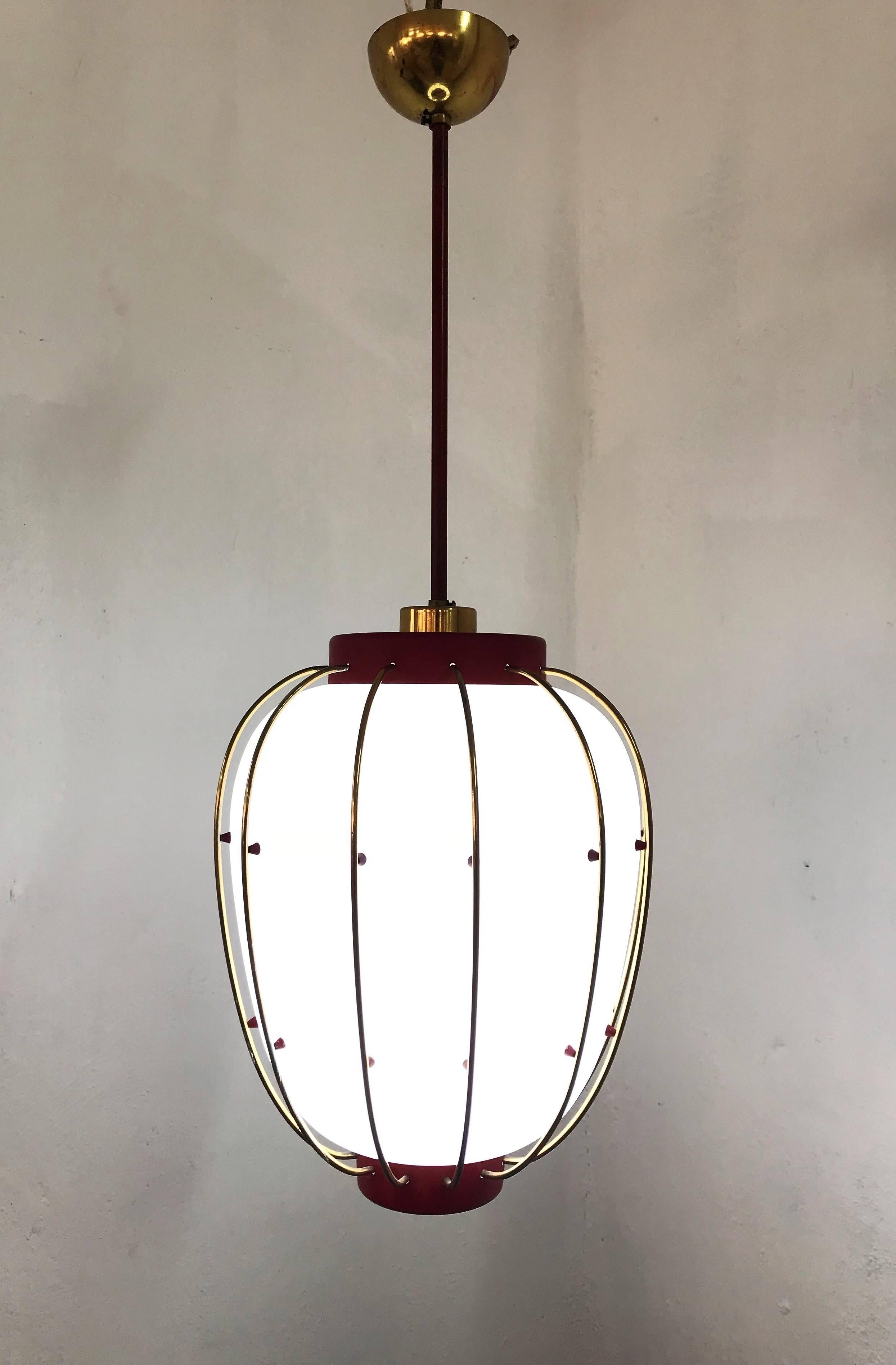 Beautiful pendant light / Lantern in lacquered metal, brass and opaline glass, attributed to Stilnovo and very much in the manner of Angelo Lelii's designs for Arredoluce from the same era.
We have 3 available. One in red and two in black. 
These