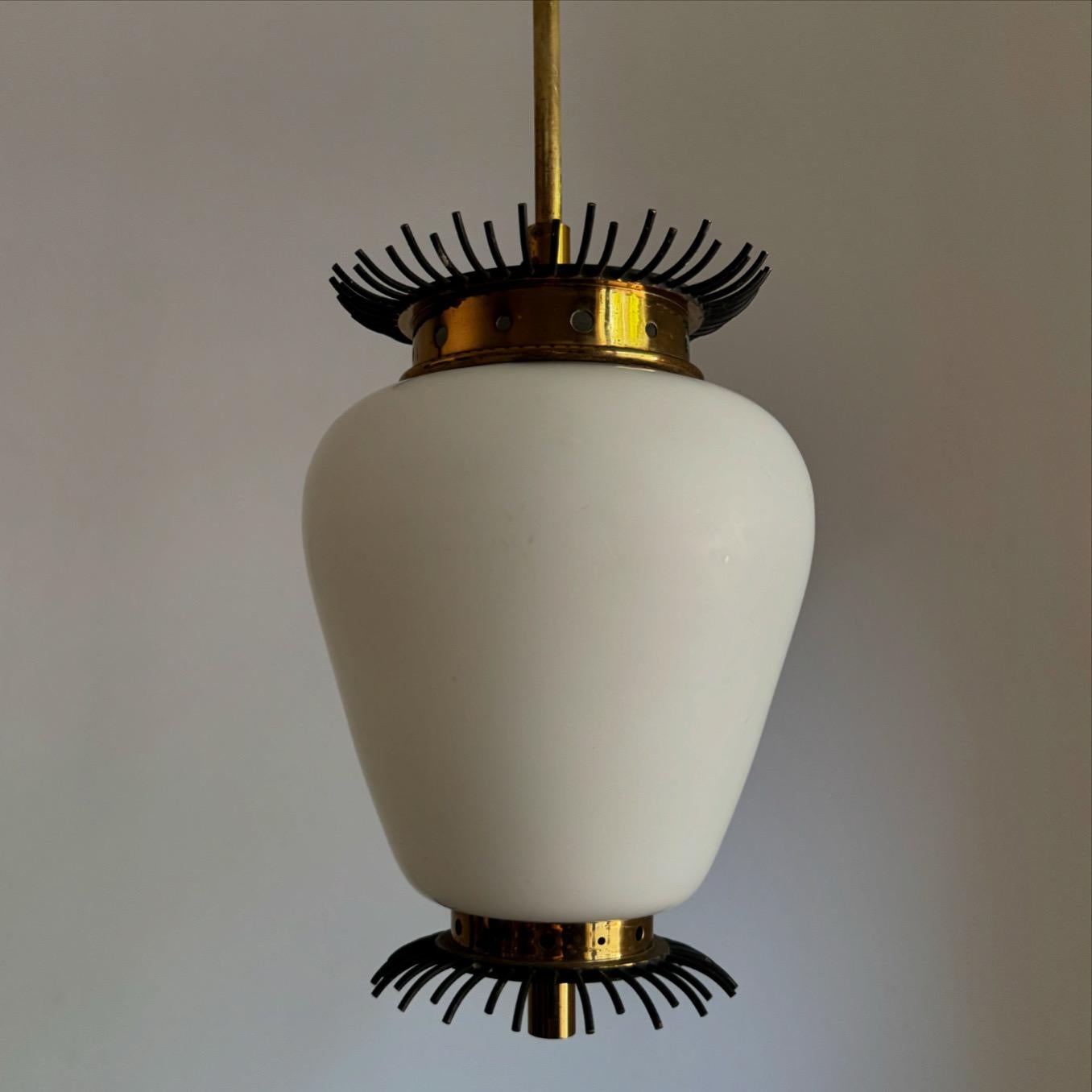 Beautiful and unique pendant light / lantern, manufactured in lacquered metal, brass and opaline glass, this lamp is made very much in the manner those designed by Angelo Lelii's for Arredoluce.
The lantern holds one e27 bulb.
Measurements:
Total