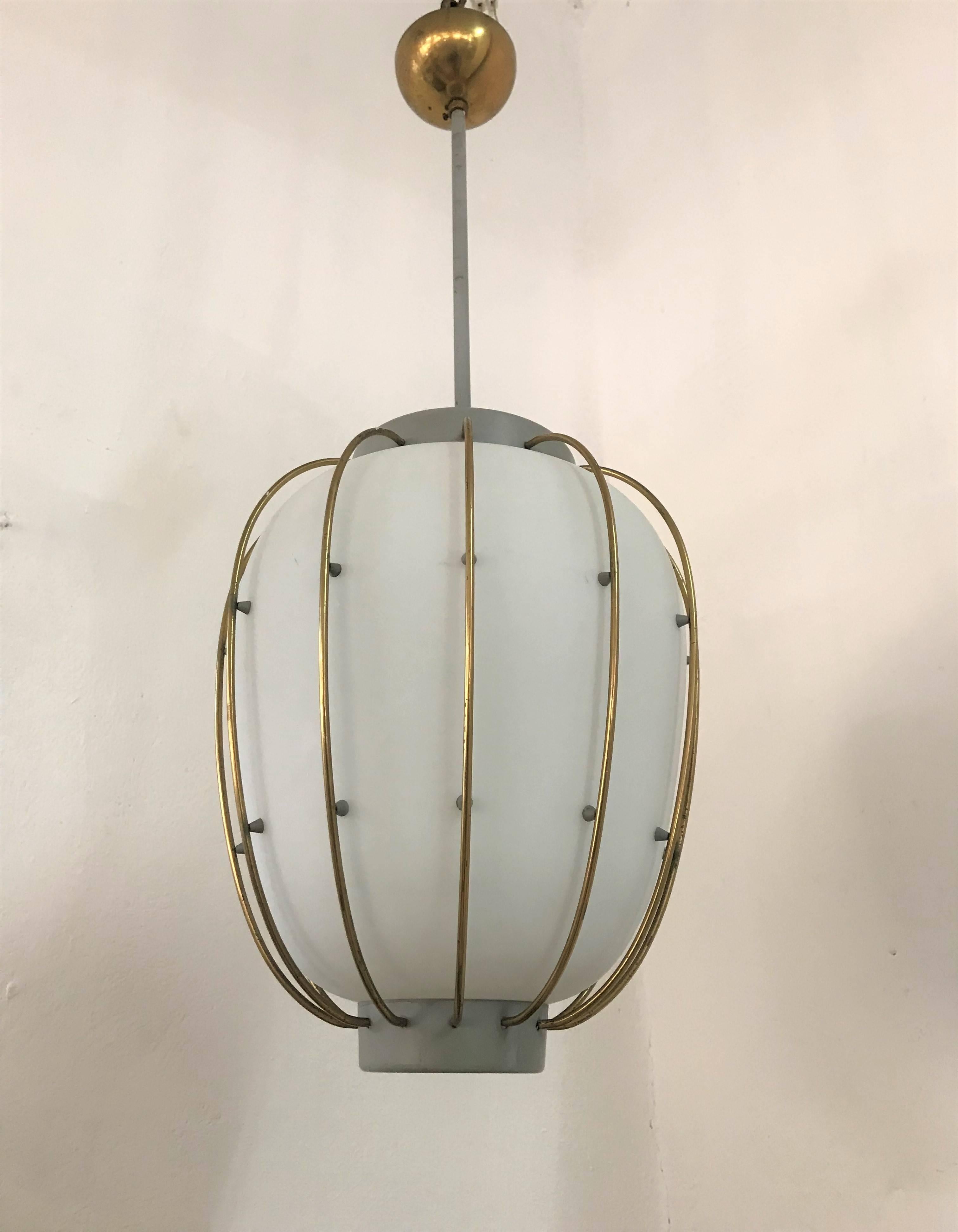 Beautiful Mid-Century Modern pendant light in grey lacquered metal, brass and opaline glass, attributed to Stilnovo and very much in the manner of Angelo Lelii's designs for Arredoluce.
This lantern holds one bulb.
There is matching (red coloured)