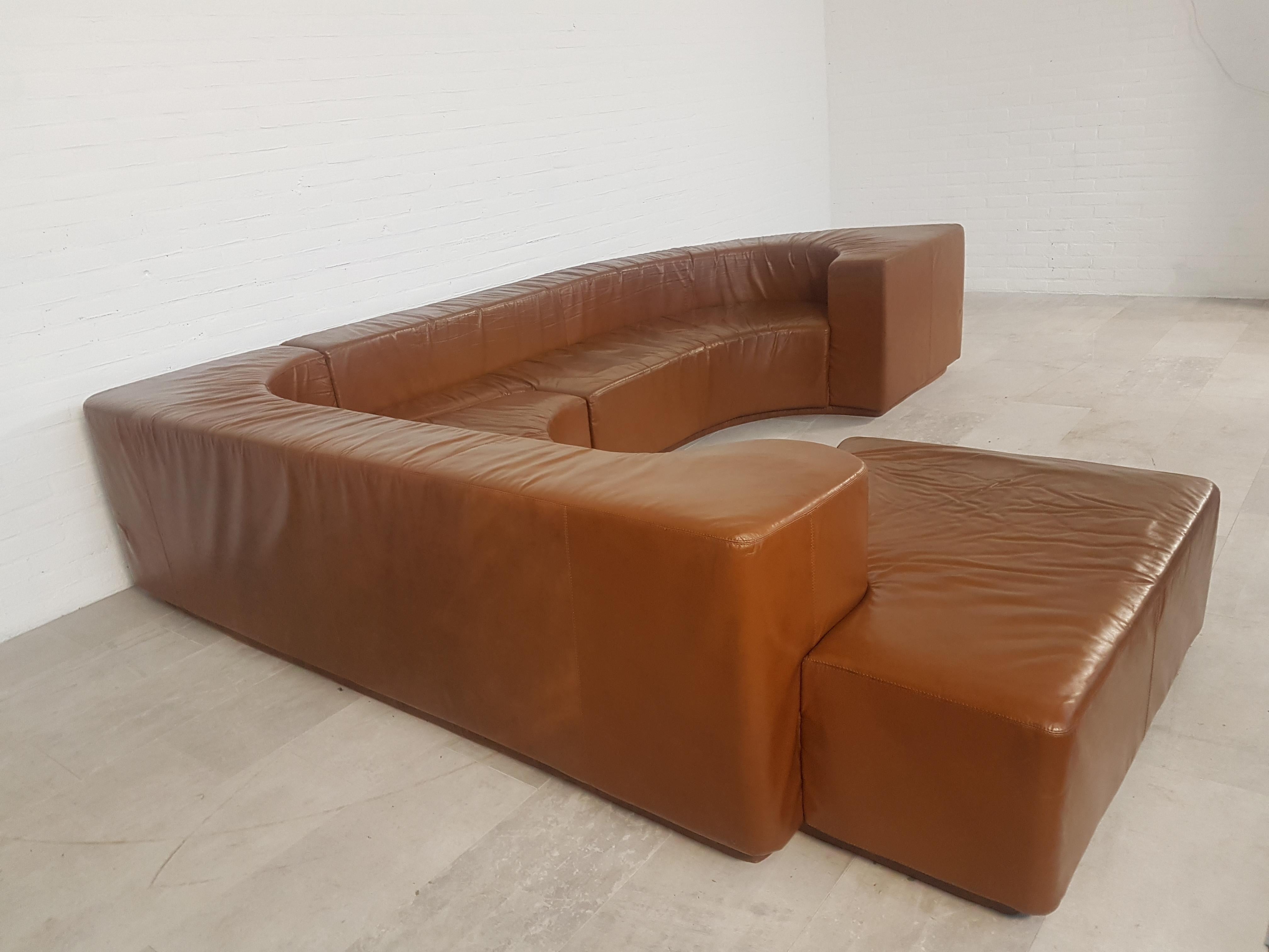 Vintage sectional conversation pit sofa in it's original brown leather upholstery.

Would fit well in an eclectic Hollywood Regency inspired interior.