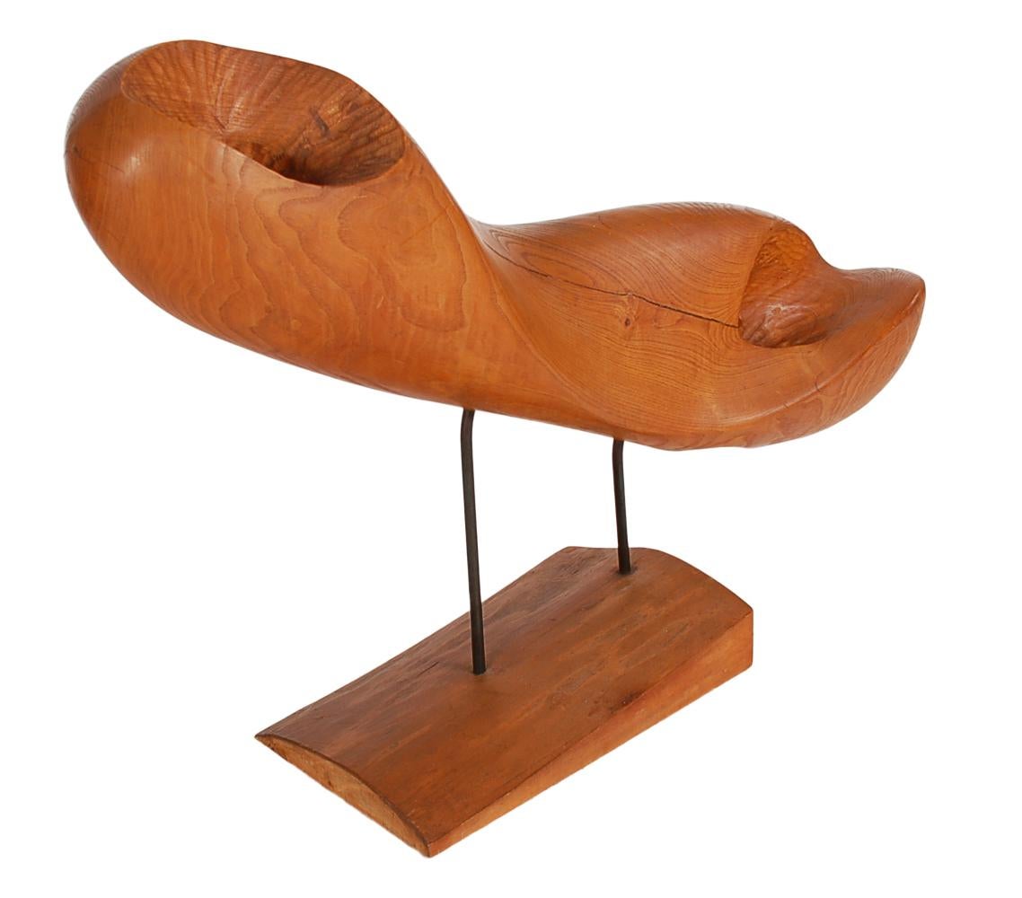 An exceptional and large work that demands attention. The abstract sculpture features a large and heavy mounted piece of exotic wood. Unmarked, circa 1970s

In the style of Wendell Castle or Don Shoemaker.
