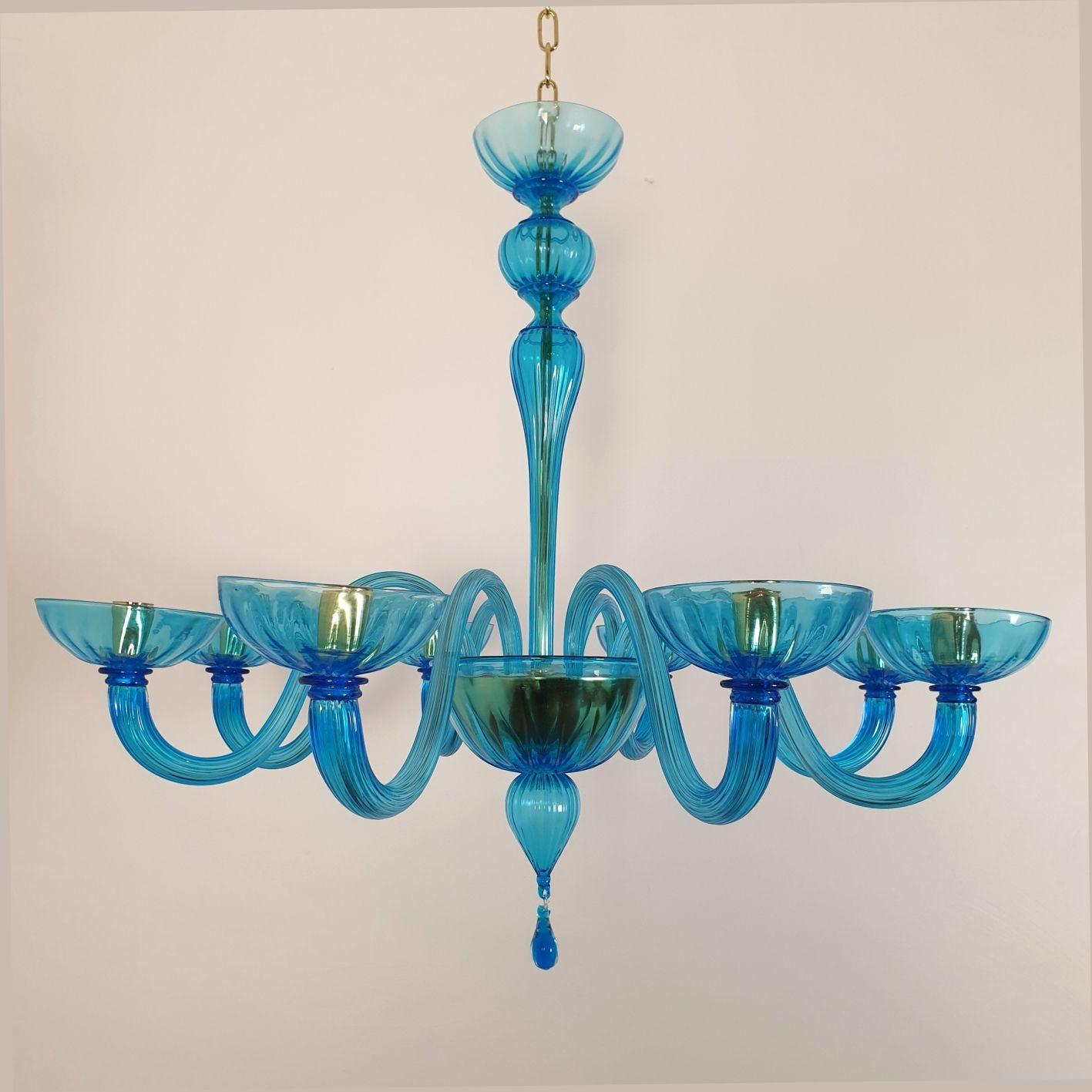 Large Mid Century Modern sky blue Murano glass chandelier, attributed to Venini, Italy 1970s.
The neoclassical style chandelier has 8 lights or arms.
It's rewired for the US with Candelabra base sockets, or E12 (or for European standards upon