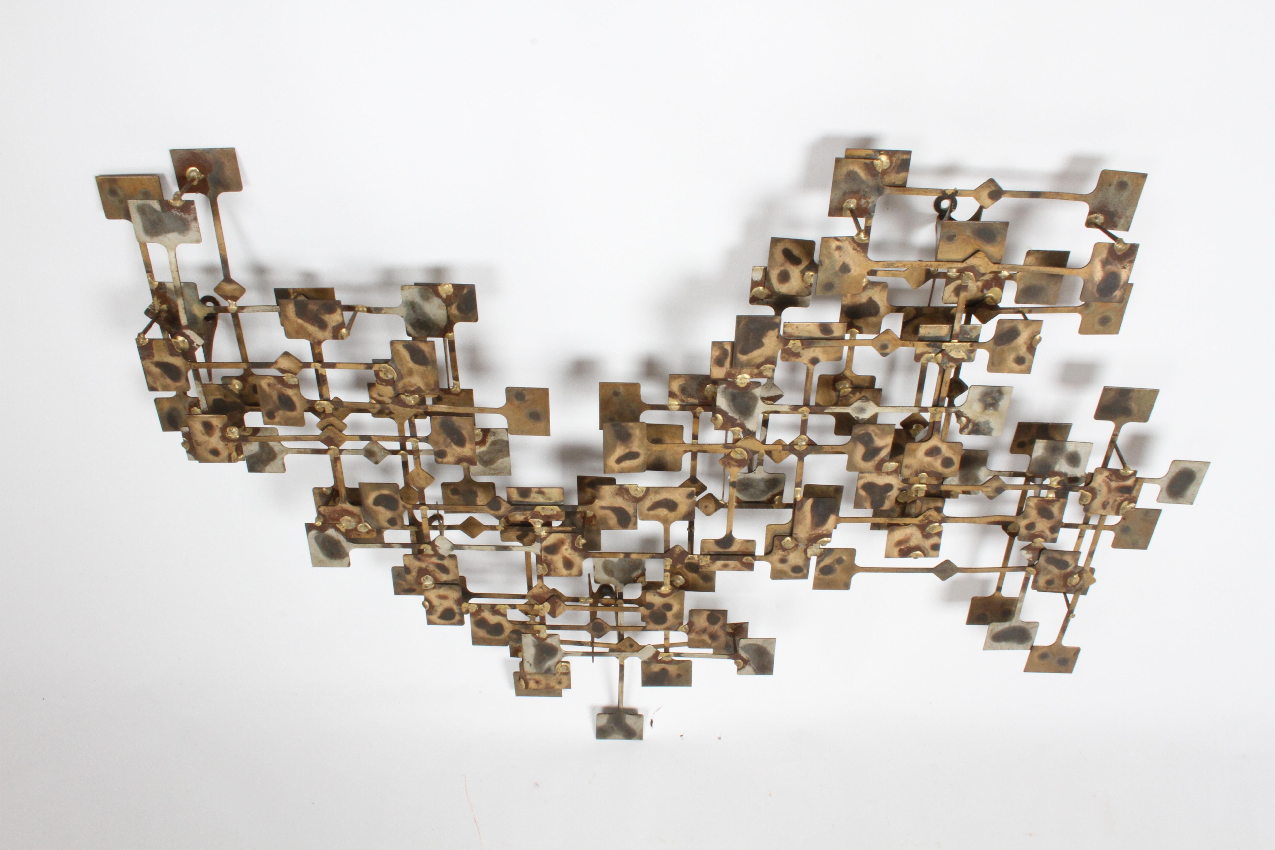 Artist Marc Weinstein Brutalist or Abstract wall sculpture from the early 1970s. This piece is constructed of flat panels in his hand burnish gold finish, in multiple layers and orientations. Marc creates (Textured dimensional sculptures). Over nice