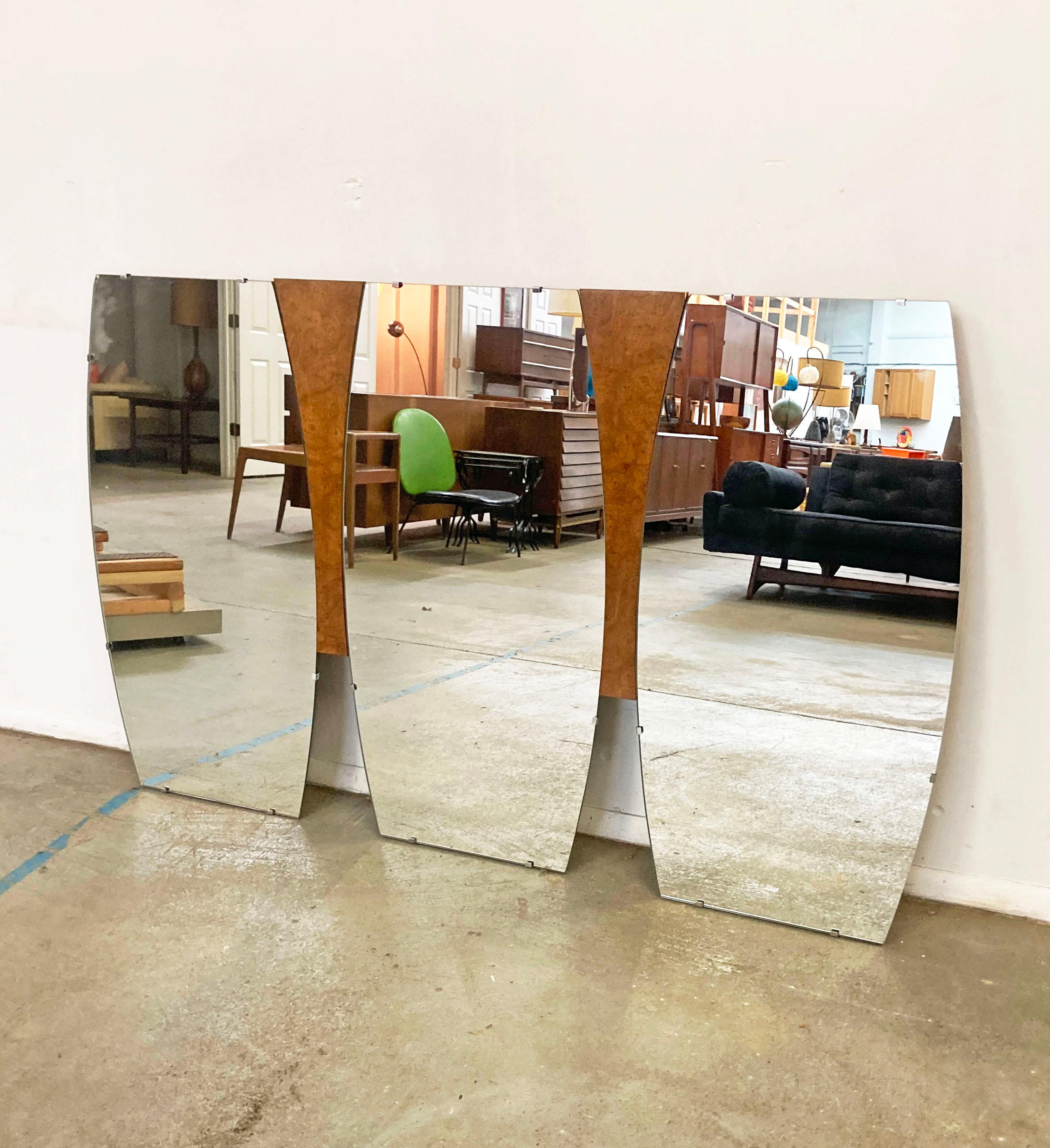 Offered is a cool large Mid-Century Modern mirror (circa 1960s). Features three mirrors attached to a burl wood base. This mirror originally sat on a dresser, but is currently being used as a wall mirror. In good condition, but has one chip on a