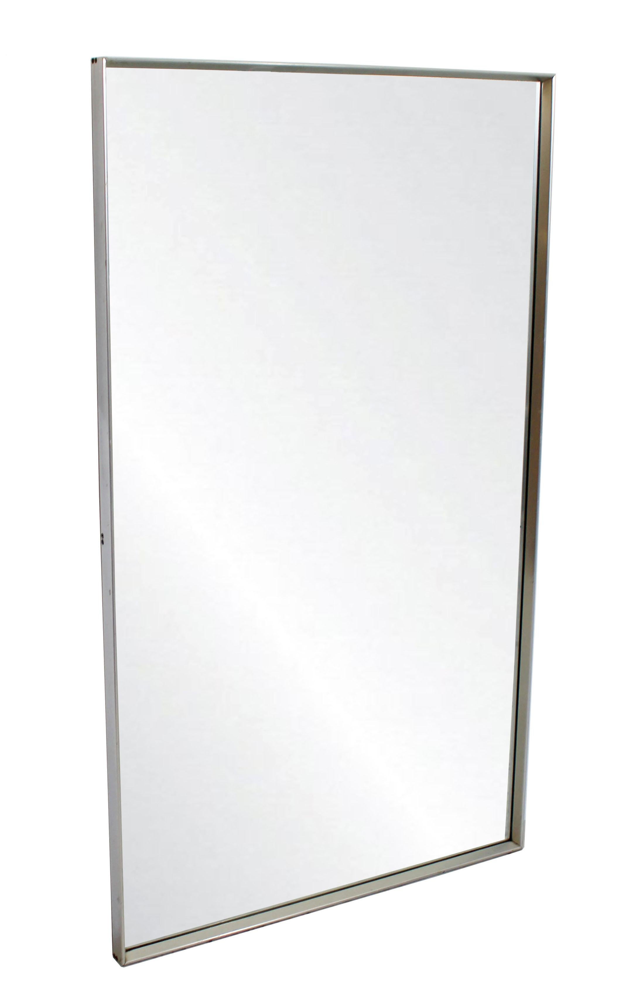 For your consideration is a minimal, chrome-plated, rectangular, wall mirror by Mirror Hart Company, circa 1960s. In excellent condition. The dimensions are 32.5