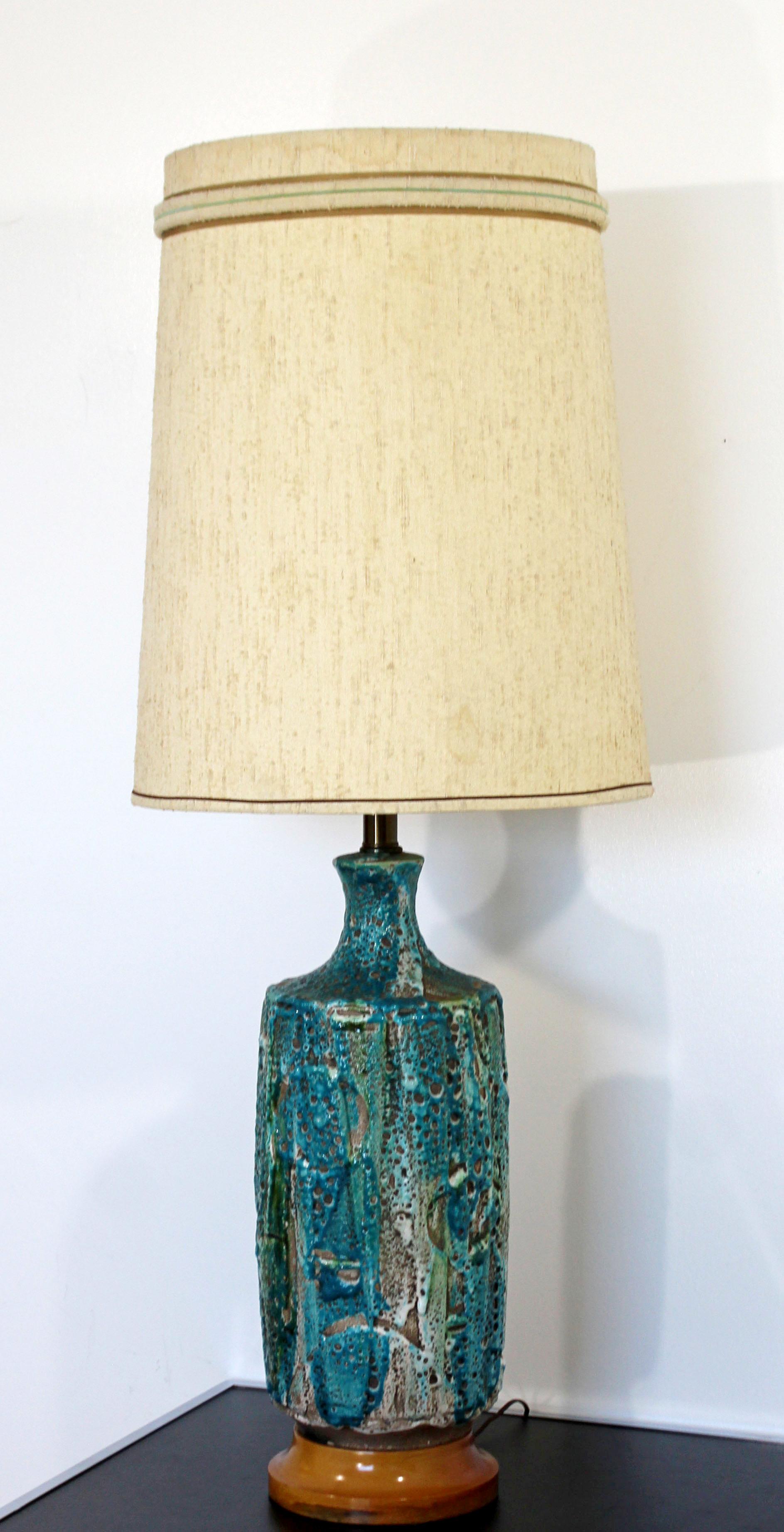 For your consideration is a magnificent, large fat lava, blue glazed, ceramic table lamp, with original shade and brass finial, made in Germany, circa the 1960s. In very good vintage condition. The dimensions of the lamp are 8.5