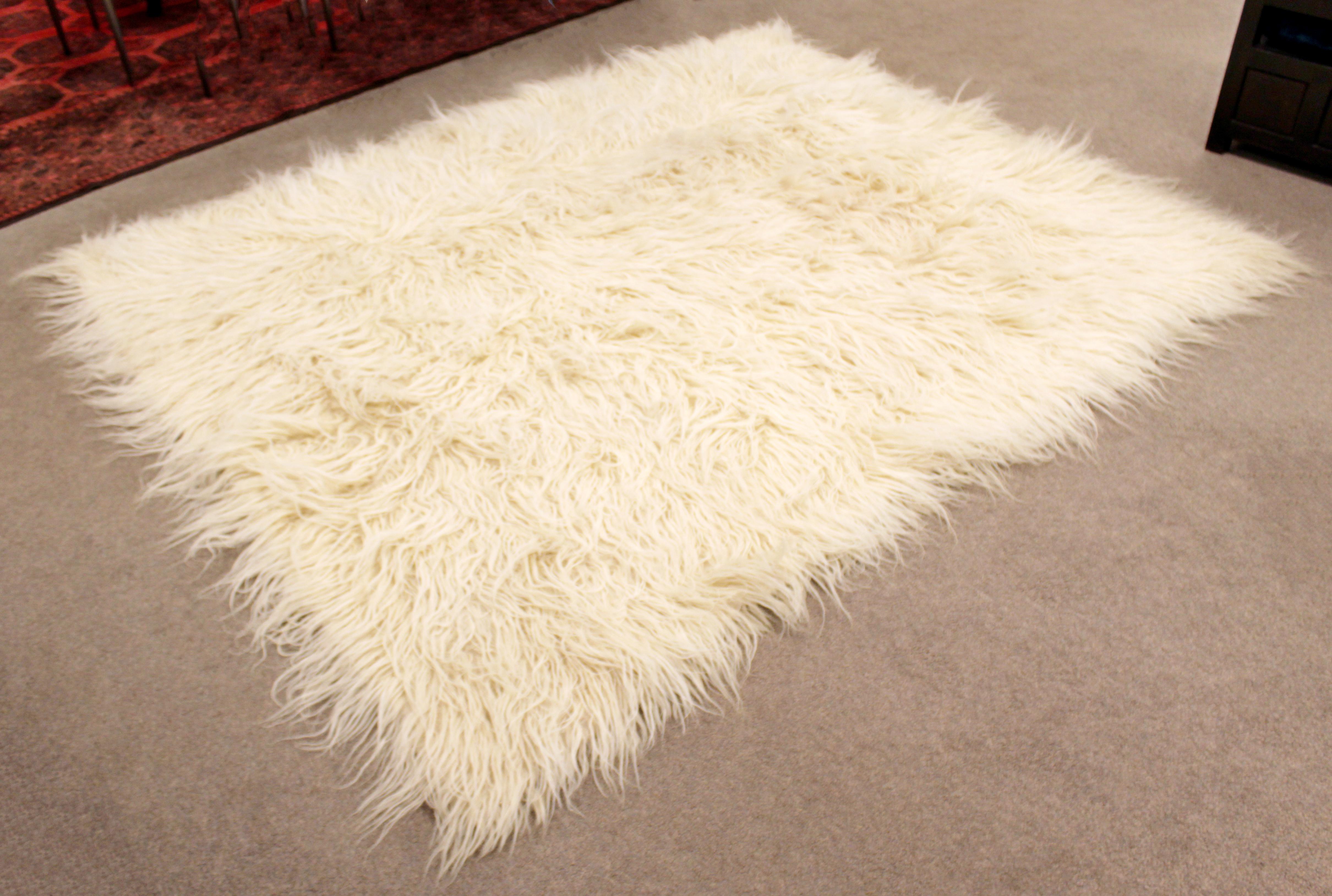 For your consideration is a ravishing and large, white flokati shag, handwoven wool area rug or carpet, circa 1970s. In excellent condition. The dimensions are 84