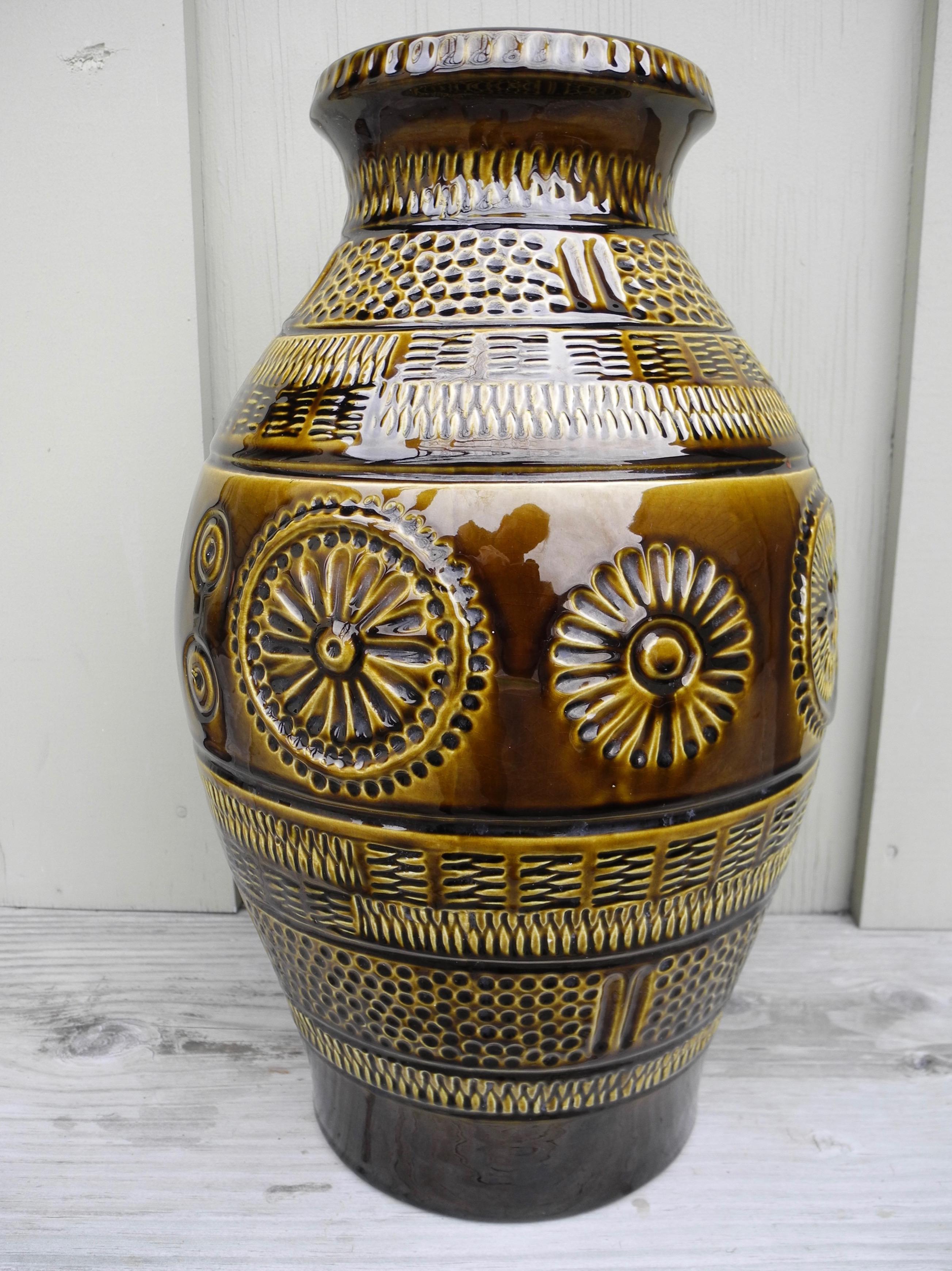 This large former West Germany ceramic vessel jar with flower motif and basket weave is typical of 1960s-1970s design.
An impressive size of 16 inches tall.