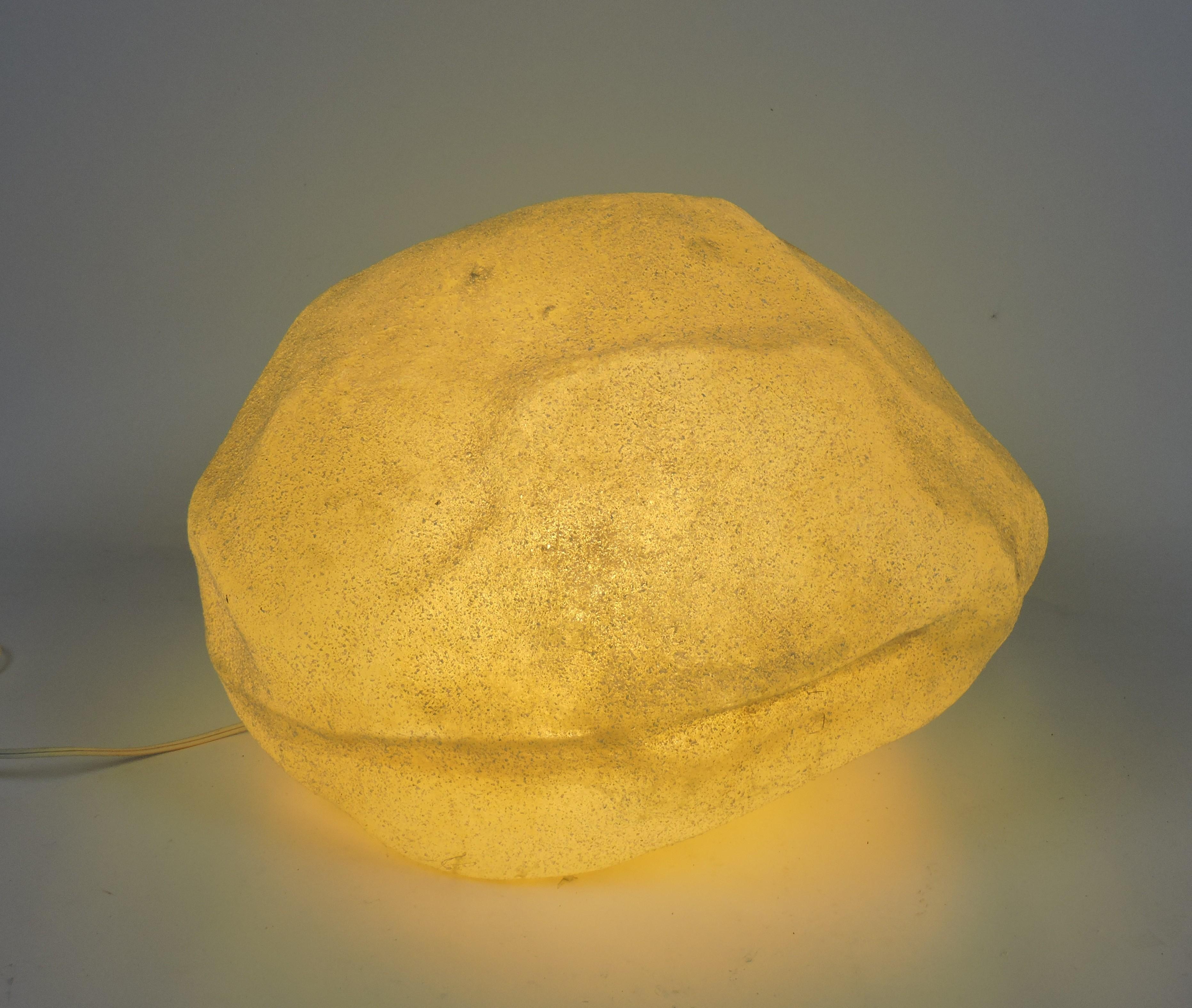 Very cool luminescent moon rock designed by Andre Cazenave and manufactured in Italy by Singleton in the 1970s. This lamp is made of translucent resin with marble powder inclusions and glows with a soft ambient light when lit. This is the second