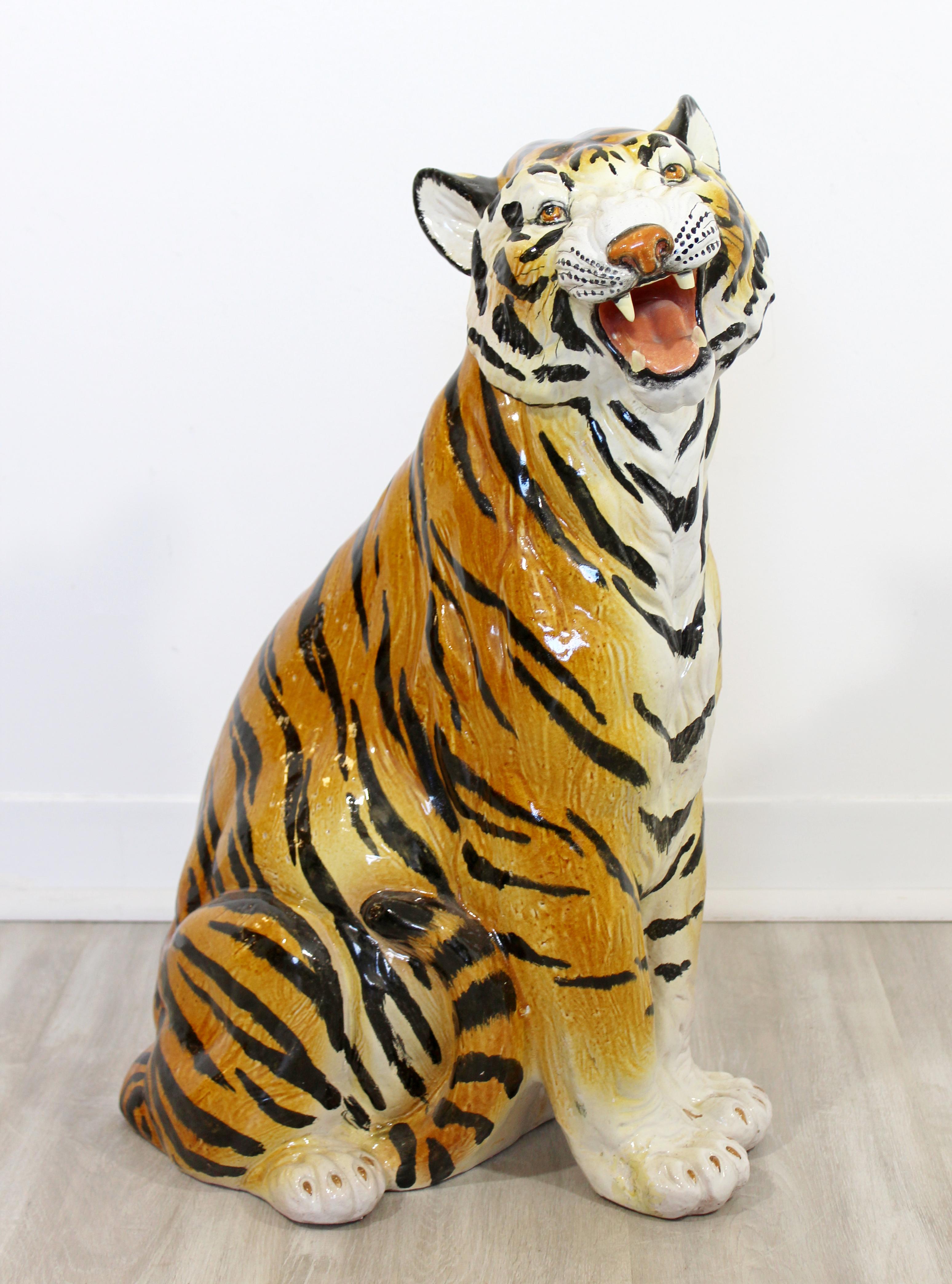For your consideration is an expressive, hand painted porcelain floor sculpture of a roaring tiger, circa 1970s made in Italy. In good vintage condition with some chips in the glaze and a broken tooth. The dimensions are 15