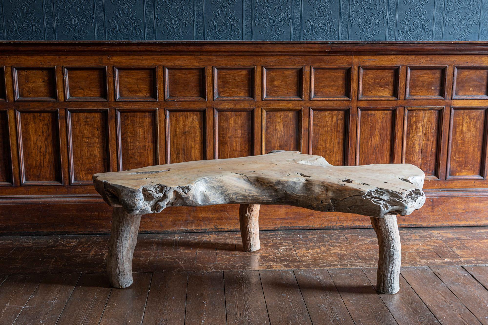 Midcentury large primitive teak root coffee table,
circa 1950.

An amazing thick single piece of solid hewn teak which has the most amazing shape color and patina.
A very tactile natural and organic vintage statement coffee table in superb