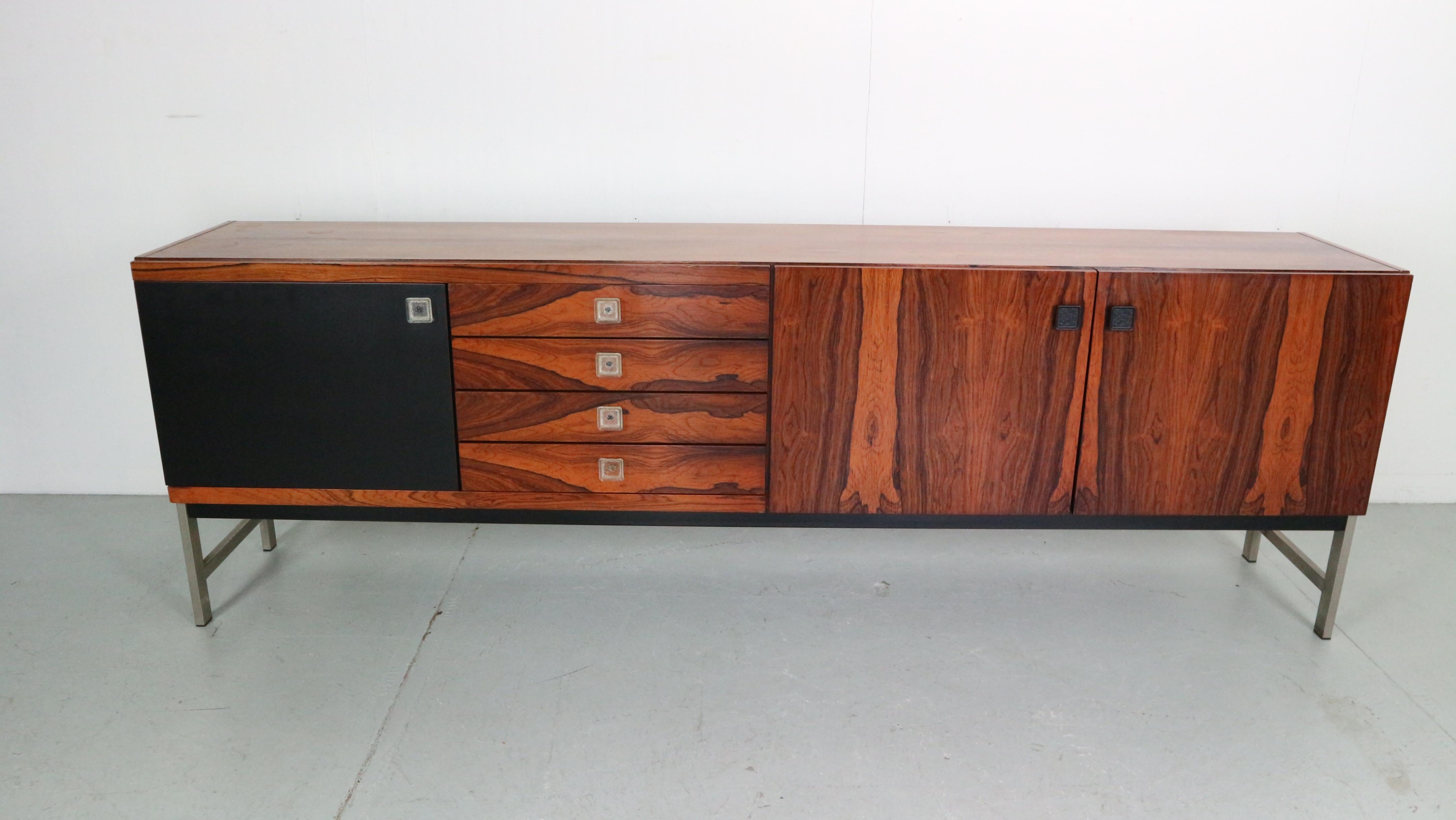 Beautiful Mid-Century Modern sideboard/credenza manufactured by Fristho famous Dutch furniture manufacture.
1960s period, the Netherlands.
Made of brazilian rosewood.
Beautiful wooden patina.

This stunning rosewood sideboard with a chrome plated