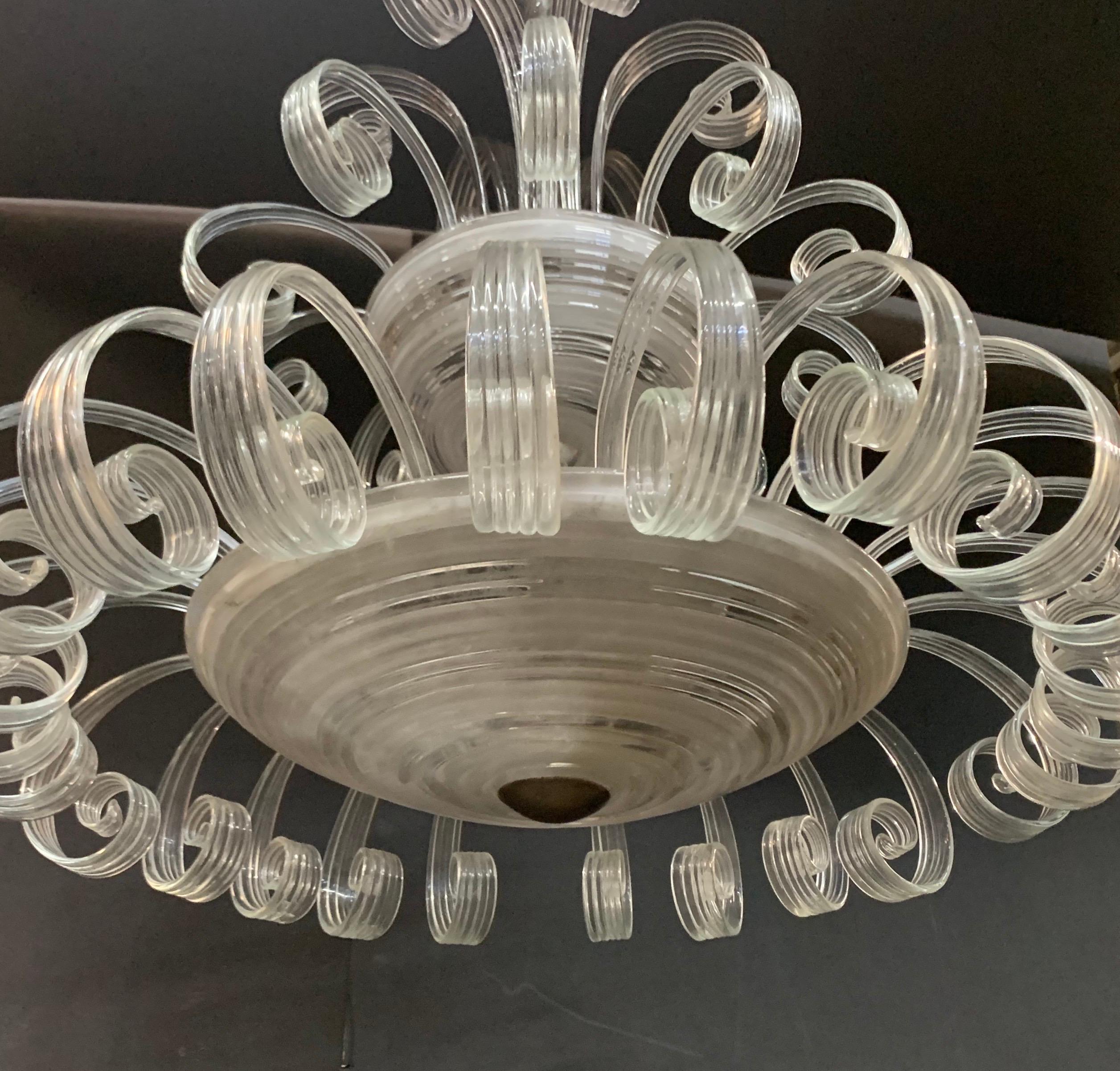 Un magnifique lustre en forme de cascade, de style Vénitien / Murano, avec 3 douilles pour candélabres dans la partie supérieure et 3 douilles Edison dans la partie inférieure, plus grande.
Entièrement recâblé et accompagné d'un auvent à chaîne et