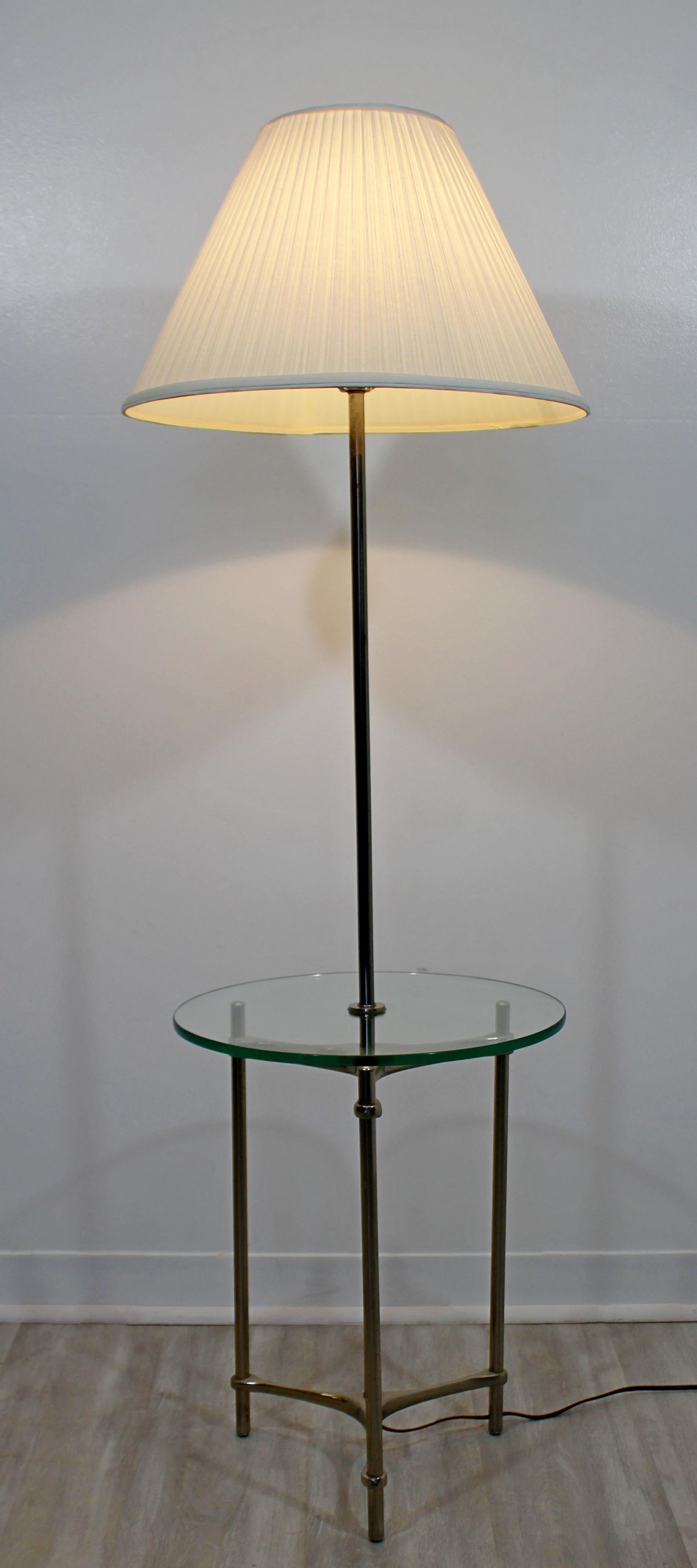 For your consideration is a fabulous, aluminum floor lamp, with glass table attached, by the Laurel Lamp Company, circa 1970s. Includes original shade and finial. In very good vintage condition. The dimensions are 18