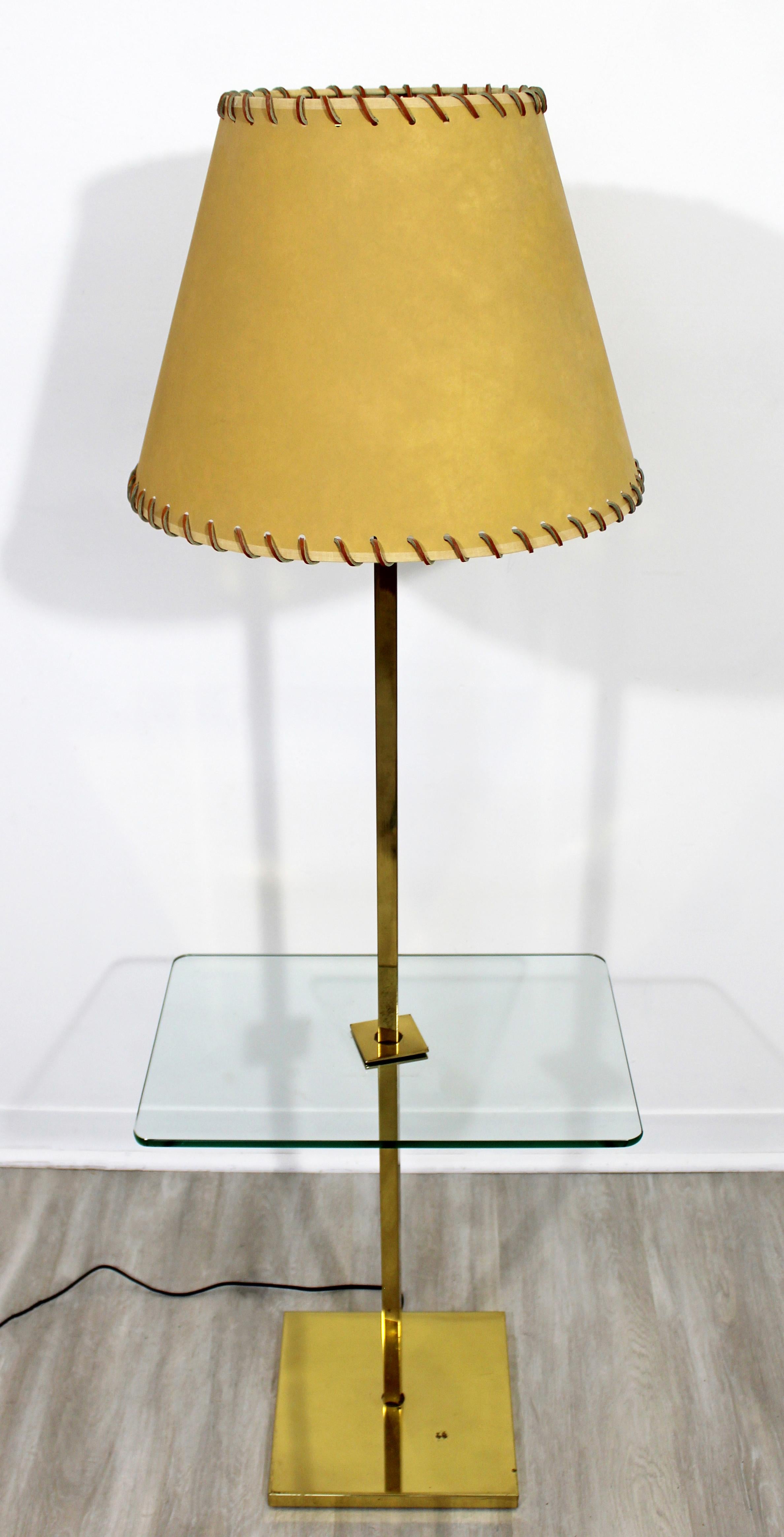 For your consideration is a gorgeous, brass floor lamp, with a rectangular glass table attached, and the original shade, by Laurel Lamp Co, circa 1960s. In good vintage condition. The dimensions are 18