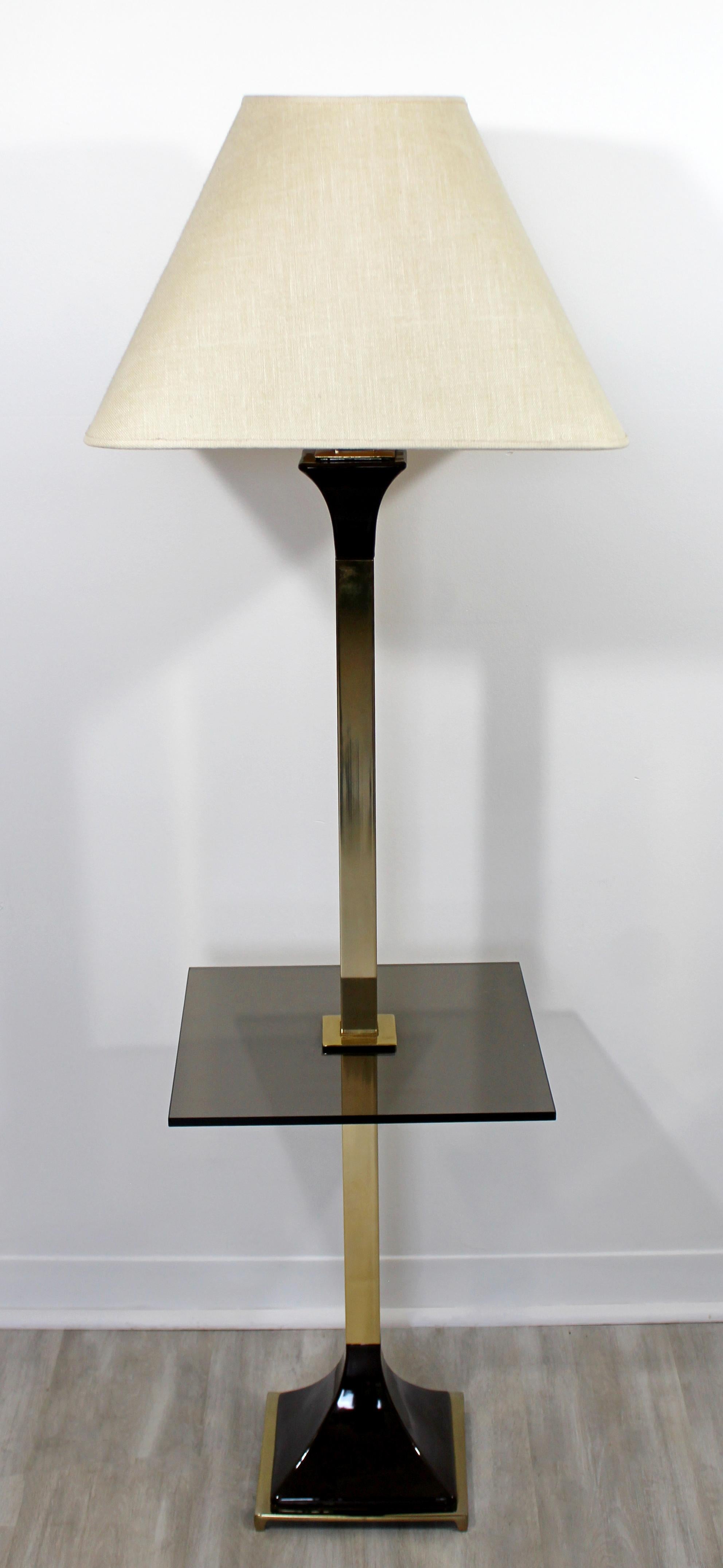 For your consideration is an understated, brass floor lamp, with a square glass table attached, and brown porcelain accents, by the Laurel Lamp Company, circa 1970s. Includes original shade and finial. In excellent vintage condition. The dimensions