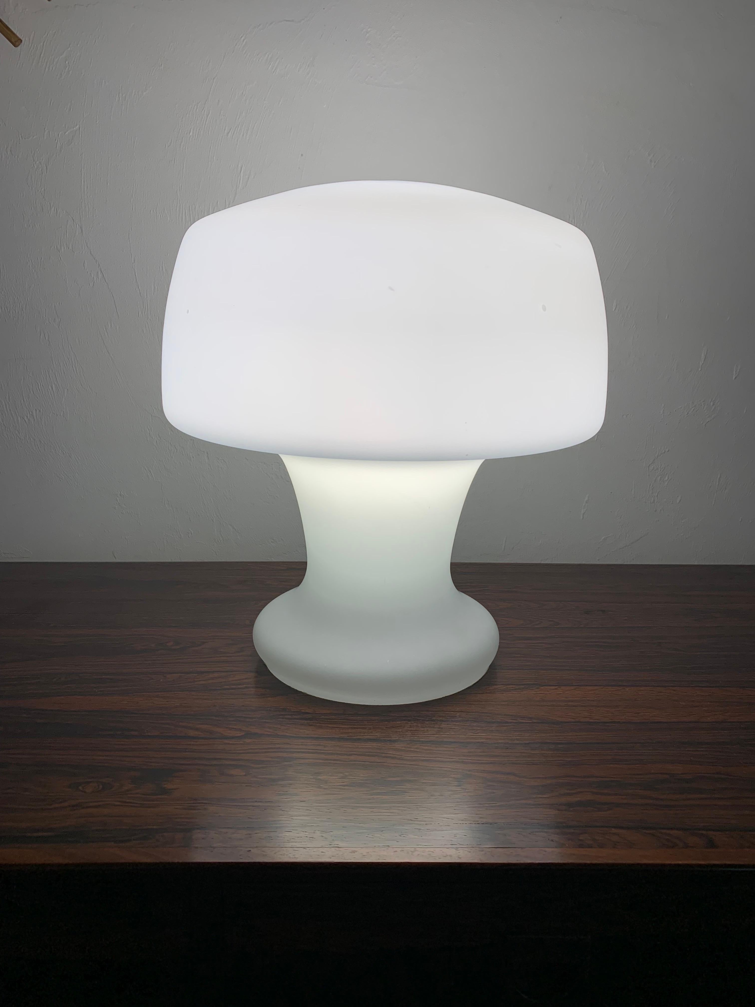 Mid century modern Laurel Mushroom table lamp. Blown opaque white glass forms a unique sculptural mushroom shape. Made from on solid piece of glass with a cord and switch to turn it on and off. True vintage piece. 

13” wide
13” deep 
14” high 