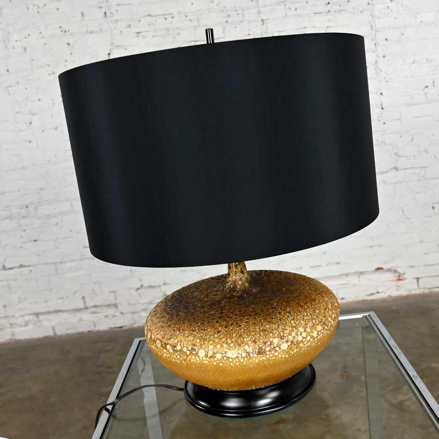 Gorgeous Mid-Century Modern lava glazed large scale squatty table lamp with new black faux silk drum shade. Beautiful condition, keeping in mind that this is vintage and not new so will have signs of use and wear. This lamp has been totally gone