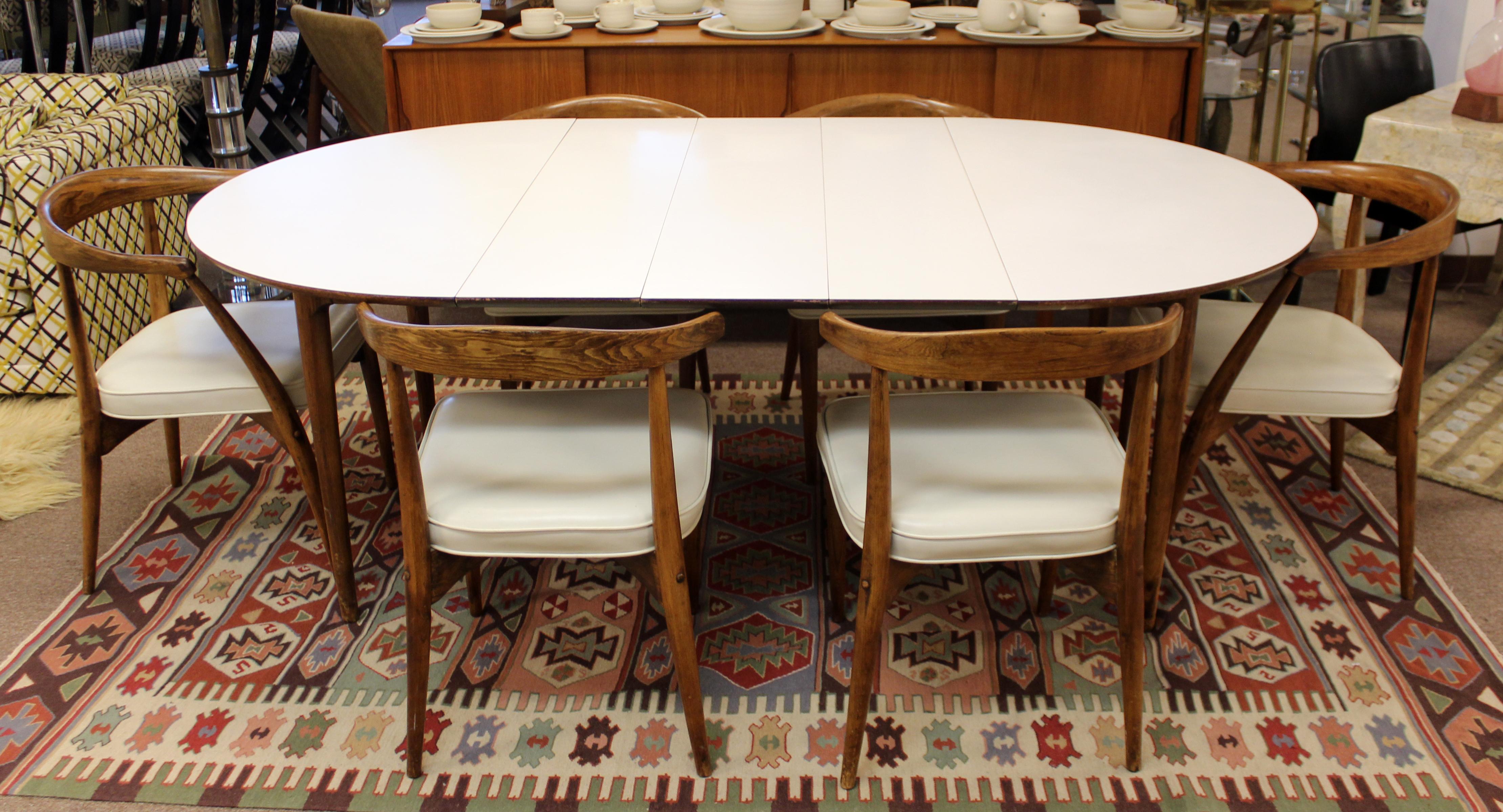 For your consideration is a classically luxe dining set, including table with three leaves and six side chairs, designed by Lawrence Peabody, circa 1950s-1960s. In excellent vintage condition. The dimensions of the table are 47