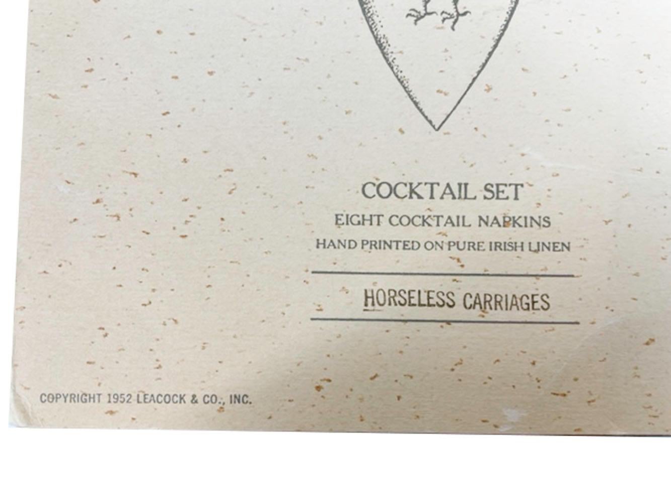 Set of 8 printed linen cocktail napkins in their original folder, by Leacock and copywritten 1952. Each napkin is decorated with the image of a different early automobile with its make and date.