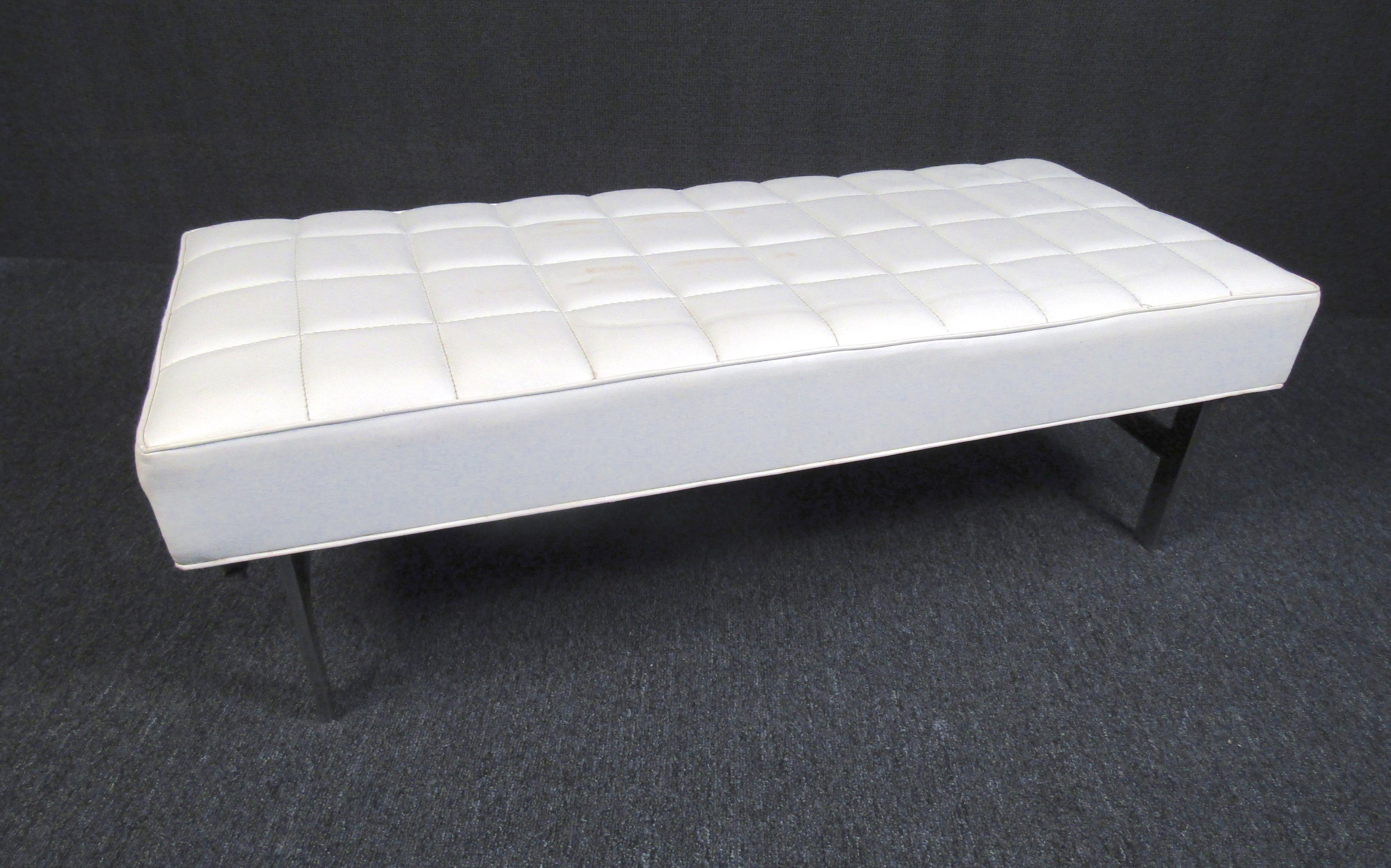 This elegant Mid-Century Modern bench is sure to stand out in the entryway to a room or living space. A comfortable white leather surface provides durability and a sleek look while being supported by chrome legs. Stylish, simple, and sophisticated,