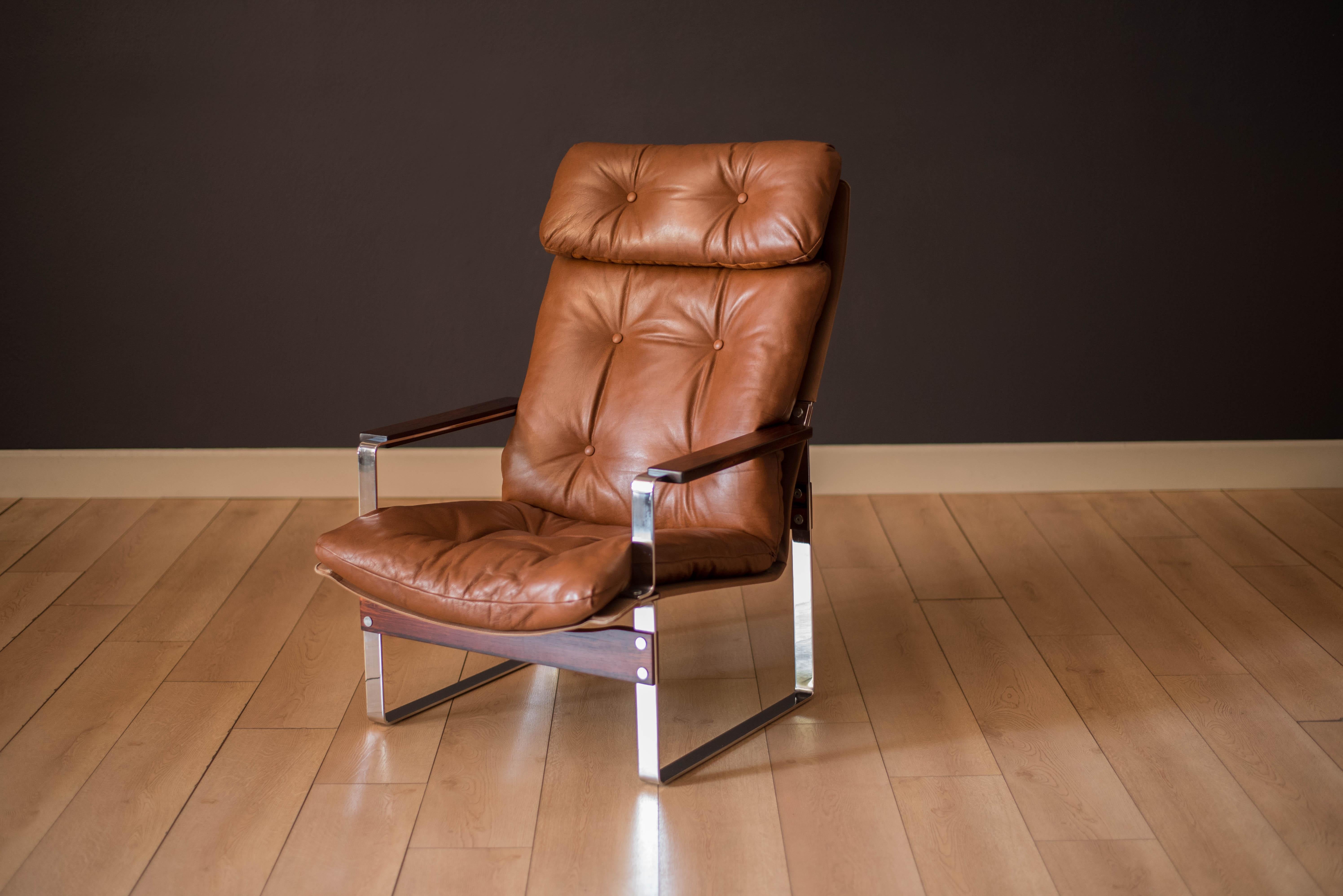 Vintage high back rosewood armchair designed by Richard Young for Merrow Associates circa 1970's. Features comfortable down cushion seating in chestnut brown leather supported by a sculptural chrome base. Perfect to use as a corner or accent lounge