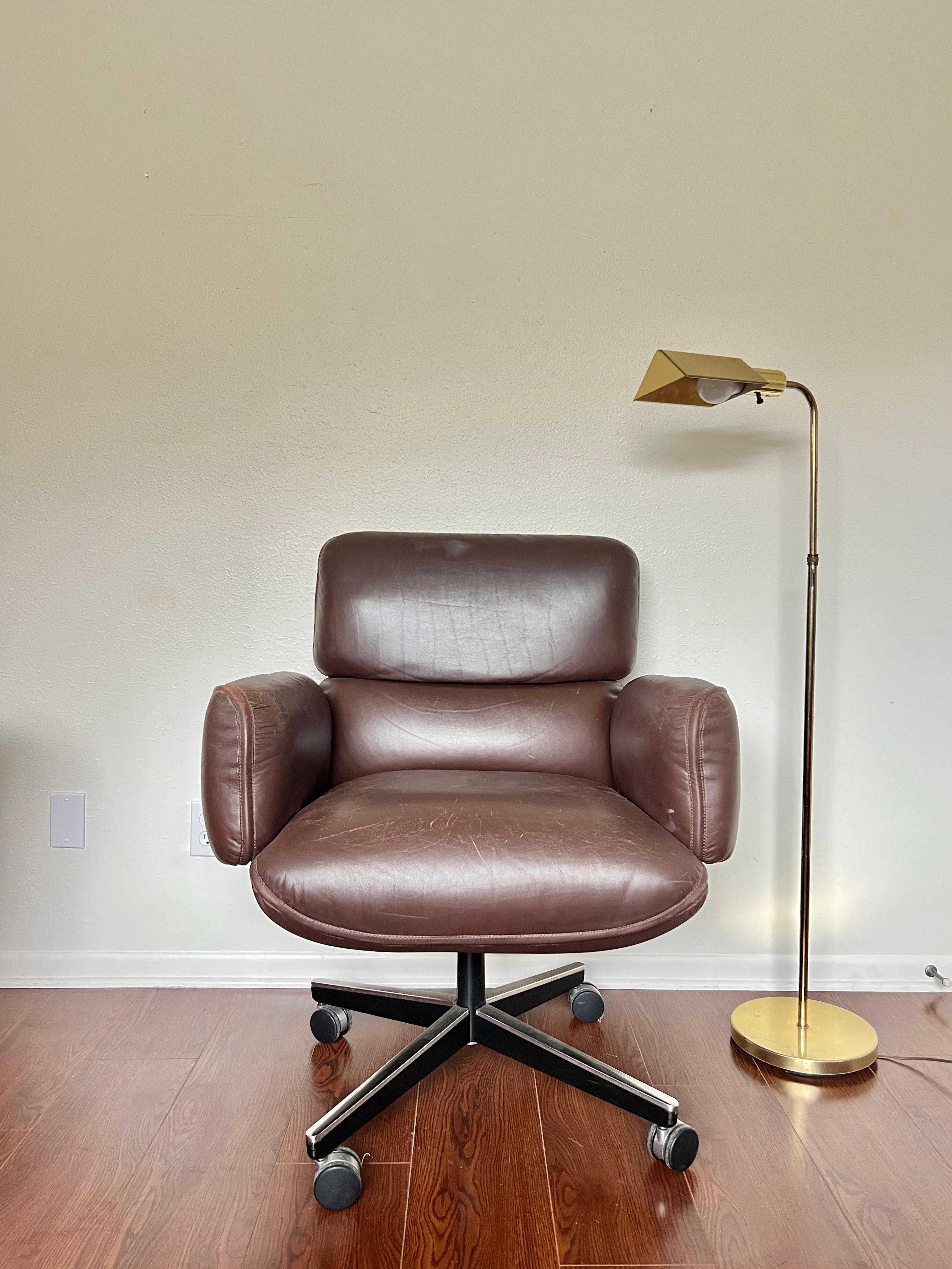 A gorgeous leather desk chair by Otto Zapf for Knoll International, circa 1970s with knoll tag still attached. Constructed of cushioned sections, with the top head section and arms removable. The chair base is height and tilt / recline adjustable