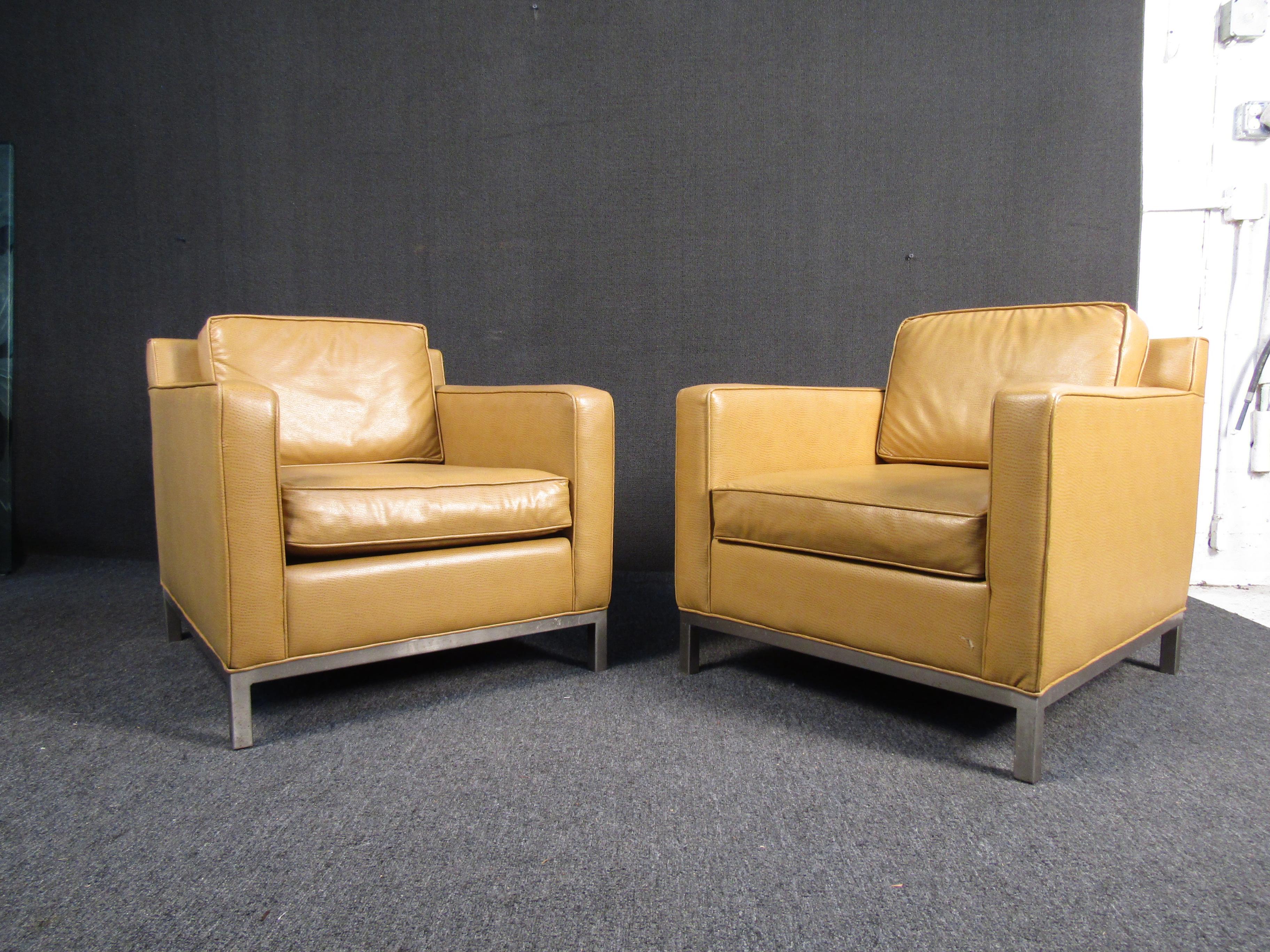 Pair of brown leather lounge chairs. These chairs are covered in a very supple brown leather and sit on solid metal frames. The pop of color is perfect for any lounge area. 

Please confirm item location with seller (NY/NJ).