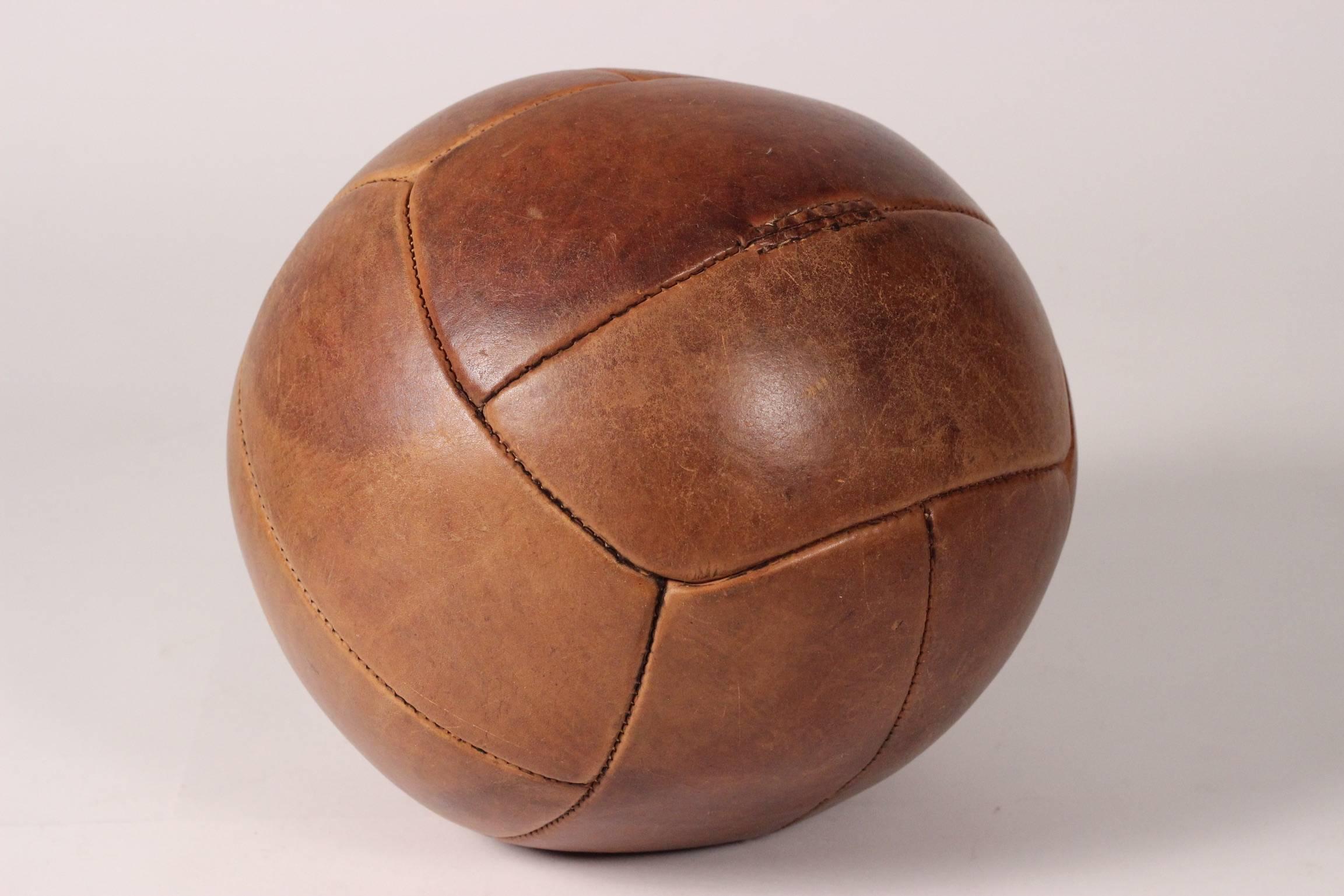 Early to mid-20th century leather medicine ball in good condition with wonderful patina that only comes with genuine wear and age.