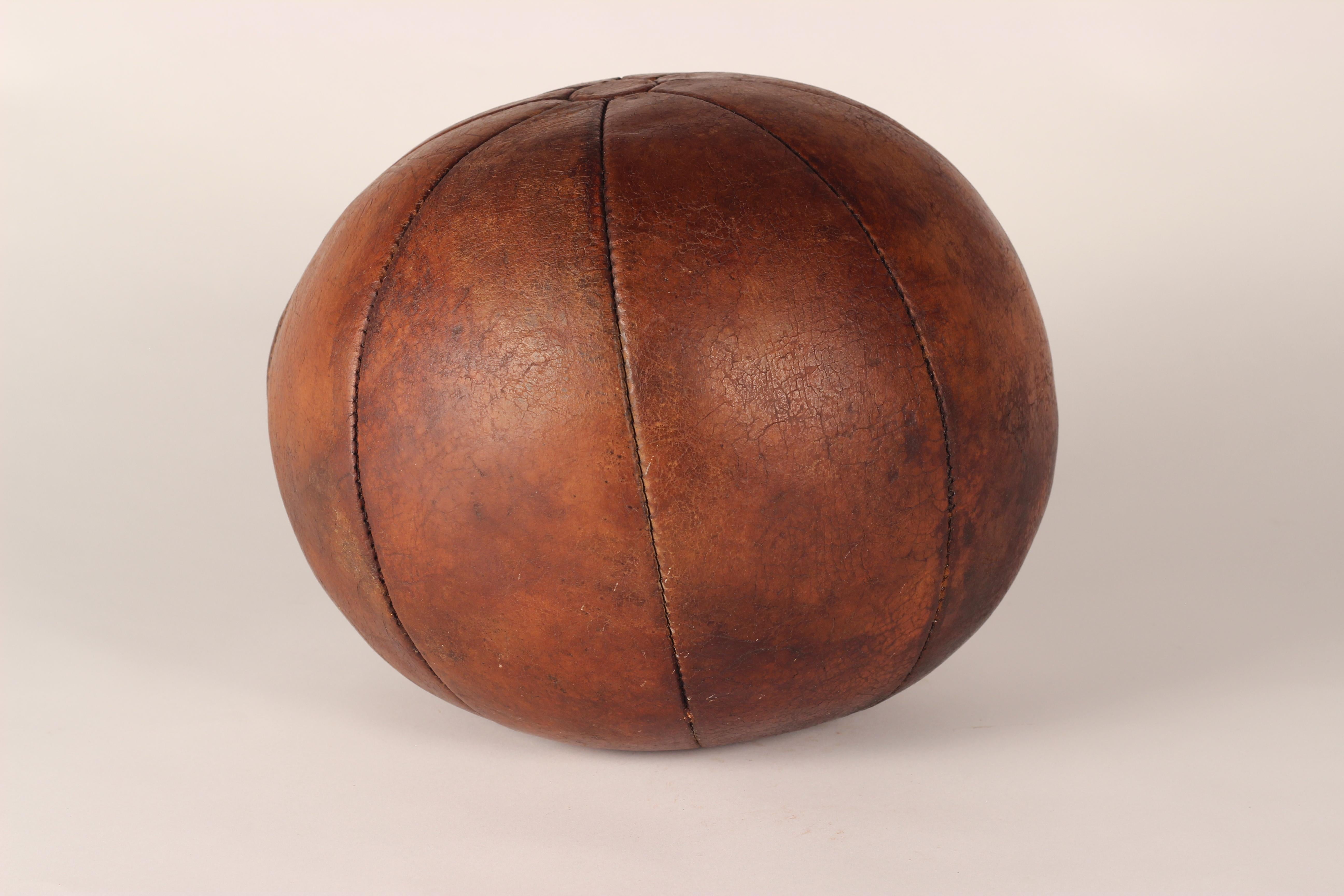Early to mid-20th century leather medicine ball in good condition with wonderful patina that only comes with genuine wear and age. 2.5 kg in weight. 

General note: Shipping quotes, as supplied by 1stdibs, are only indicative.

   