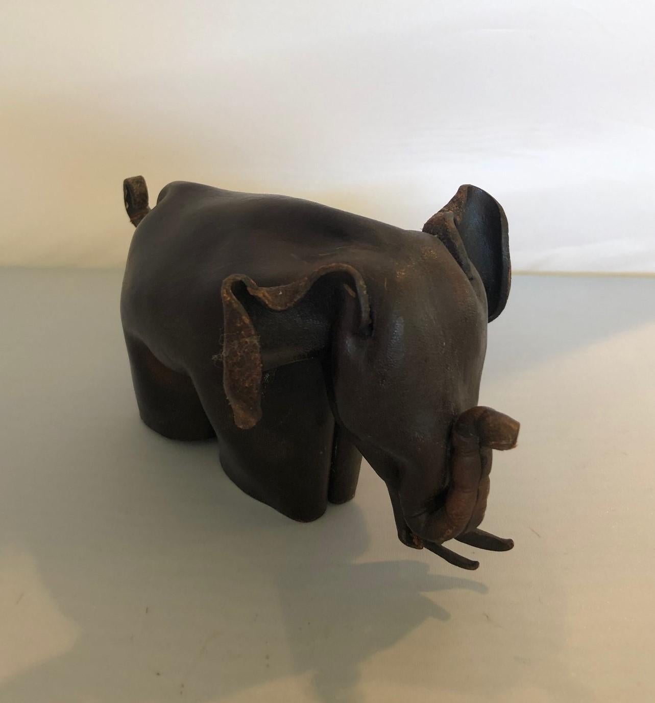 Rare Mid-Century Modern leather origami elephant sculpture, circa 1960s. The piece is made from one piece of leather that has been folded and manipulated to form an elephant. It is in the style of Deru and made in England (stamped on his right rear