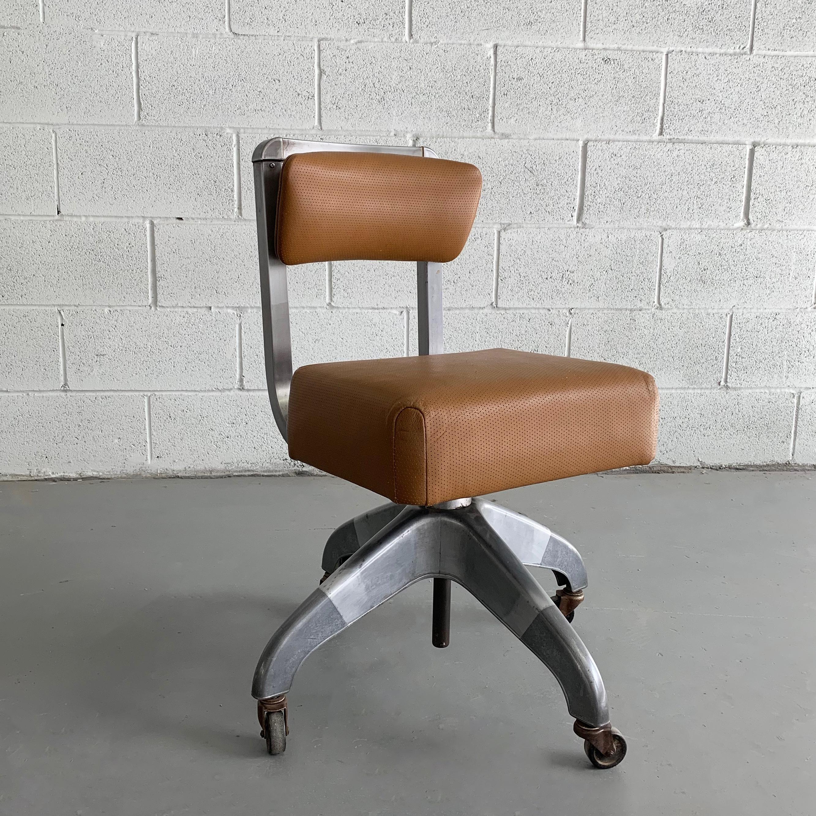 Midcentury, rolling, adjustable height, office, desk armchair by DoMore Chair Company features an aluminum frame and newly upholstered perforated tan leather seat and back.