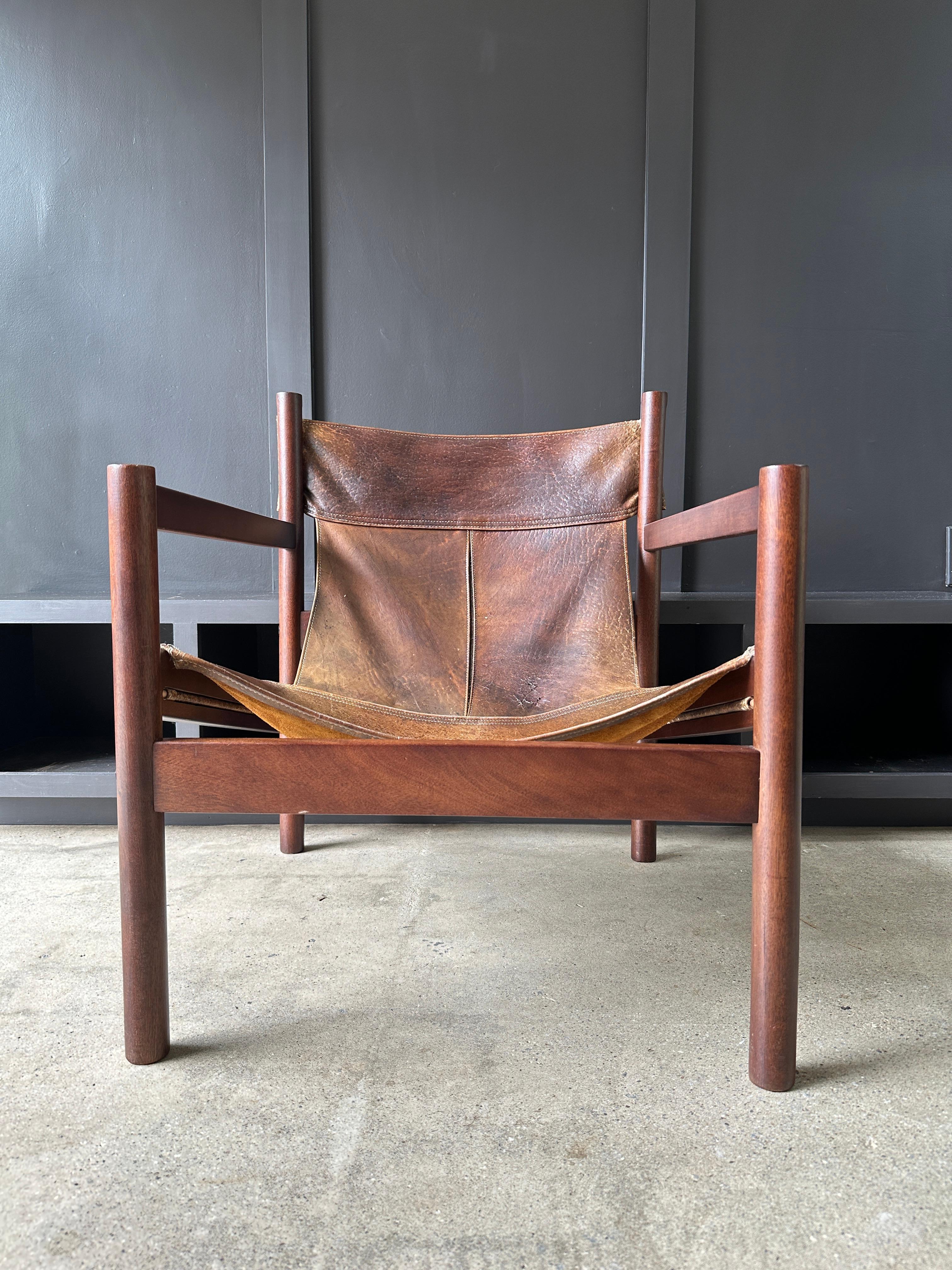Vintage ‘Roxinho’ leather safari style lounge chair by Michel Arnoult, circa 1960 Brazil.

 Armrest chair features stitched high quality leather sling seat, with Brazilian rosewood frame.
1200
27”W x 30”D x 29”H x 14.5”SH