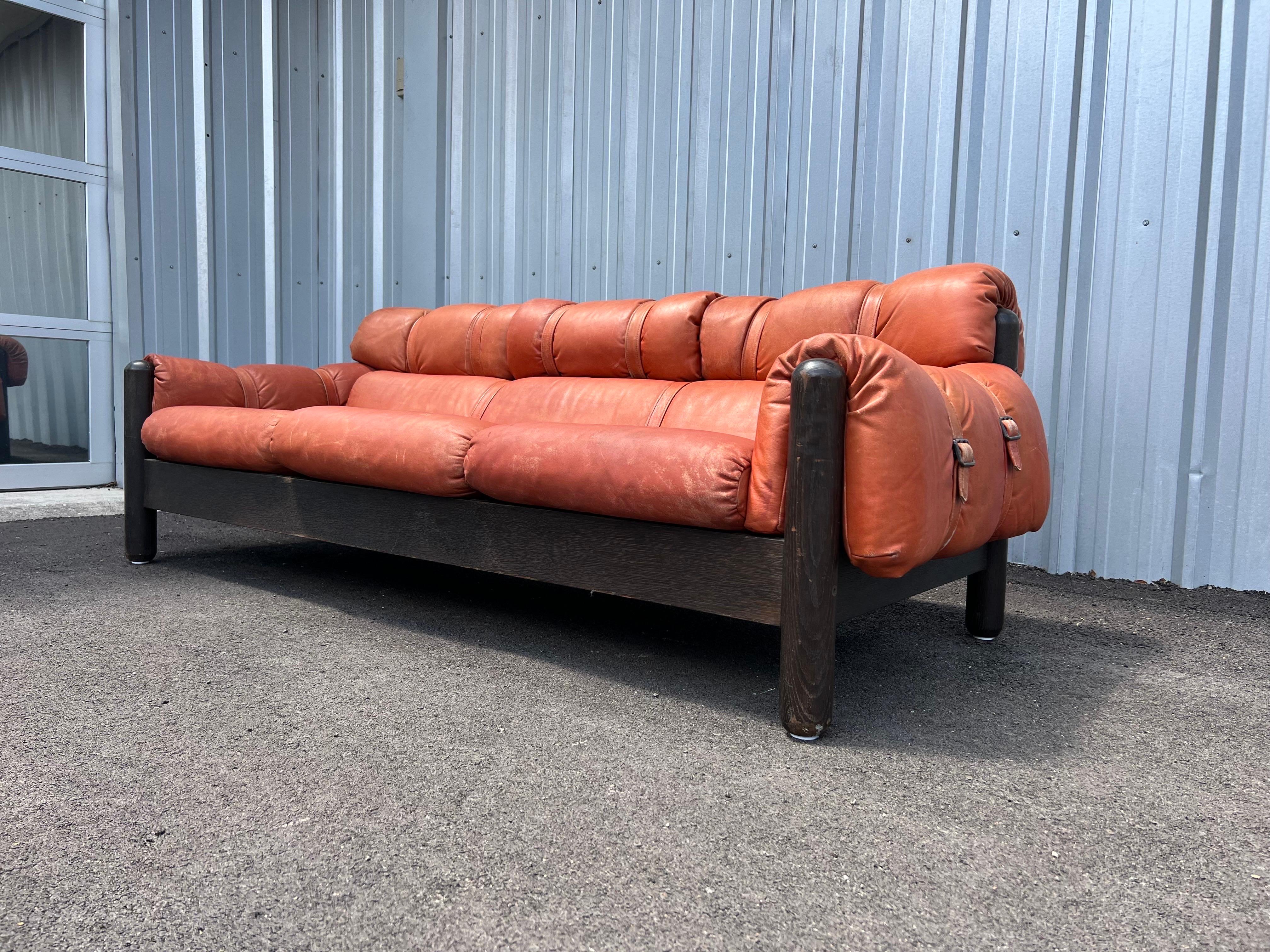 Mid-Century Modern leather sofa by FinnArena, Finland, 1960s features a frame in dark stained oak, loose seat and back leather cushions in a warm cognac color that has a nice patina. This Danish modern 3-seater sofa is in good overall vintage