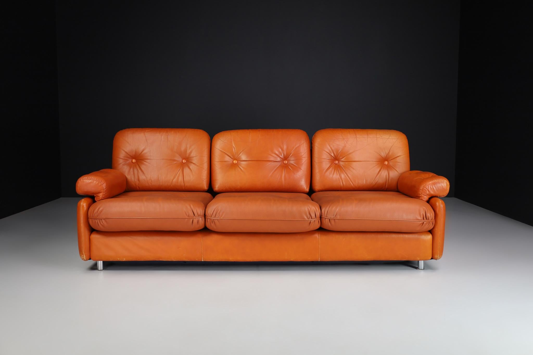 Mid-Century Modern leather three seat lounge sofa, Germany 1960s

Mid-century modern leather three seat lounge sofa manufactured and designed in Germany 1960s. It is in lovely vintage condition, with a minor patina on the leather. These armchairs