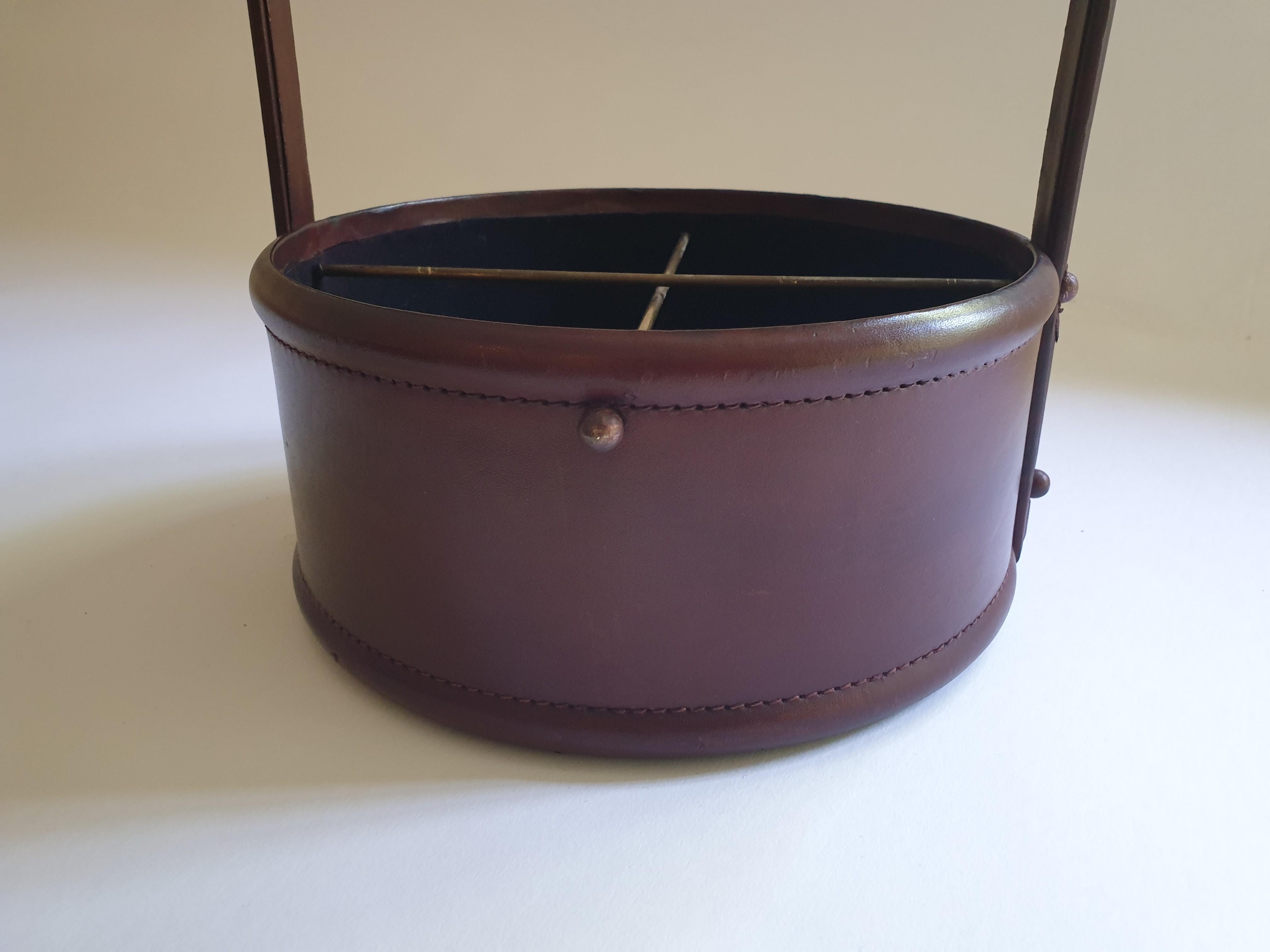 Dark red leather and brass leather wine carrier designed to take four bottles. Please note wear to leather covering to handle.