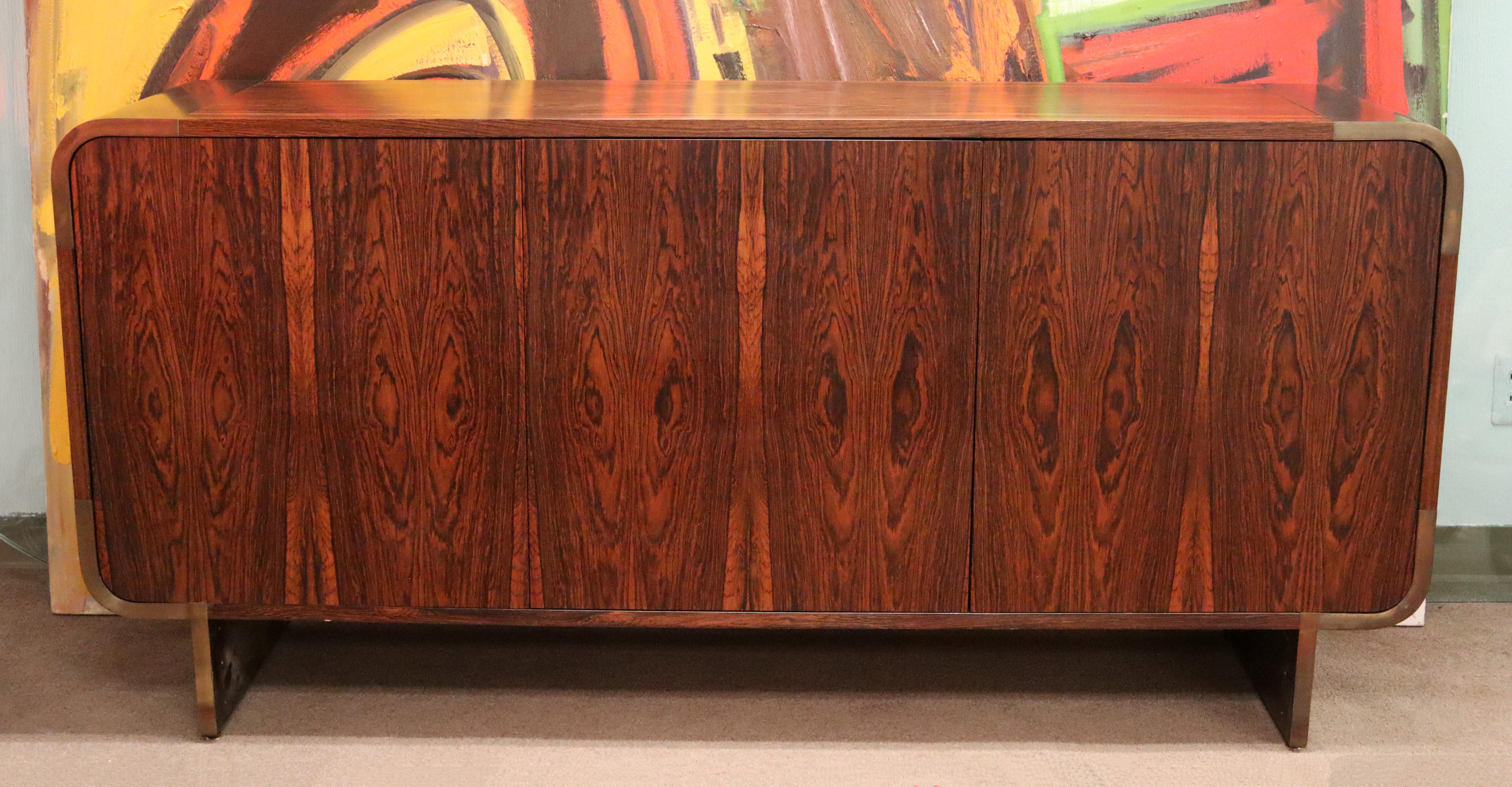 For your consideration is a luxe looking curved rosewood and bronze credenza, custom ordered by Leon Rosen for Pace. The piece is finished on all sides so can also be floating in a room, circa 1970s. In excellent vintage condition. The dimensions of