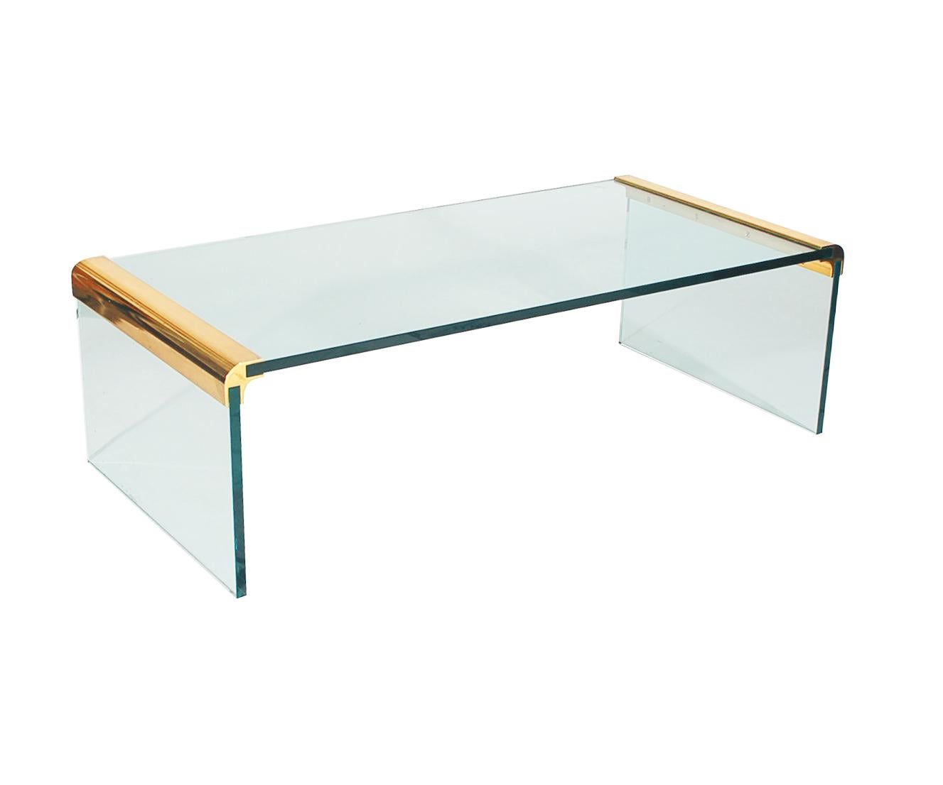 A simple modern design by Leon Rosen and produced by Pace Furniture in the 1970s. This table features extremely thick glass construction with brass brackets.