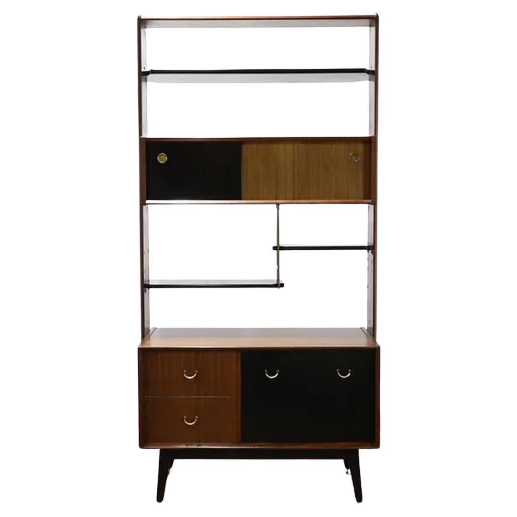 A 1960s G plan Librenza range room divider

Contrasting Tola wood and painted black sections

Consists of a cabinet at the bottom with sliding doors a drop down bureau and various shelves

finished to the back allowing it to be freestanding  as a